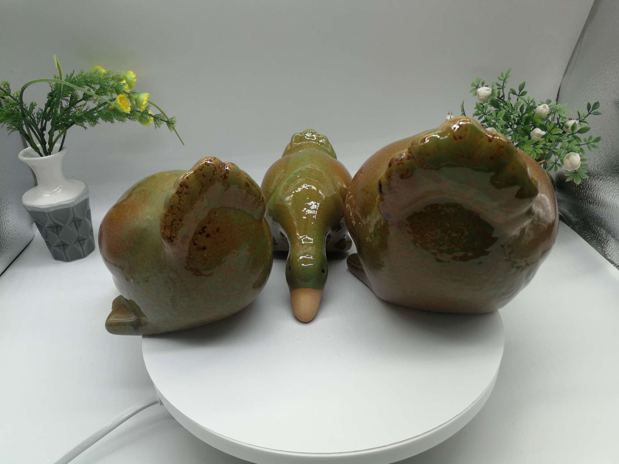 Three water playing duck figurines are available in white, green or blue undefined