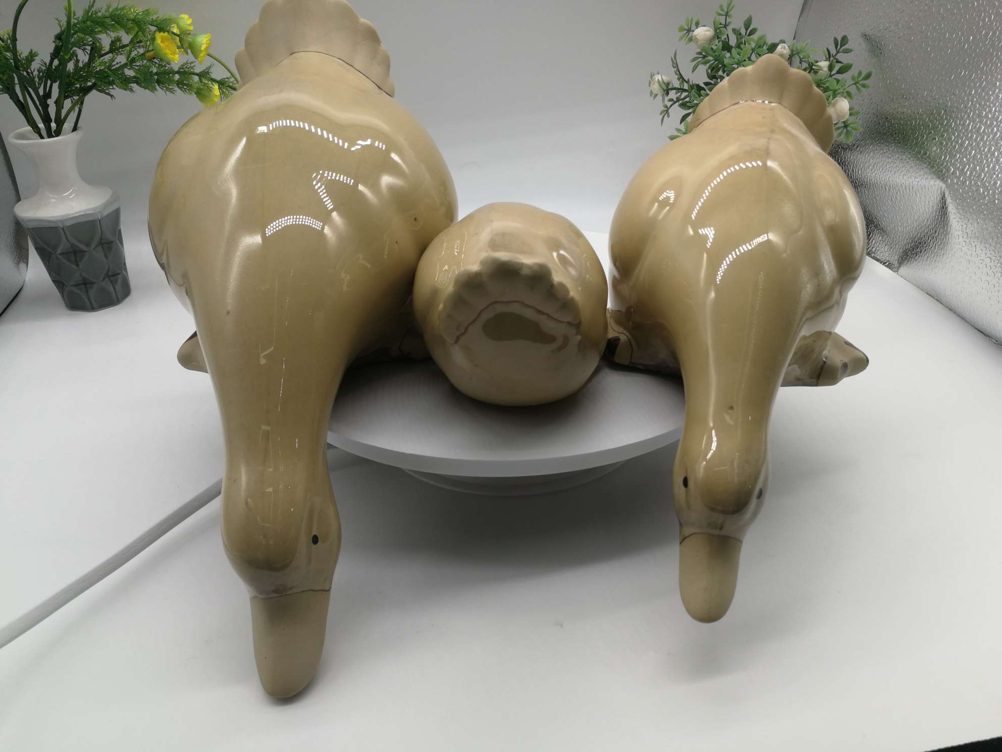 Three water playing duck figurines are available in white, green or blue undefined