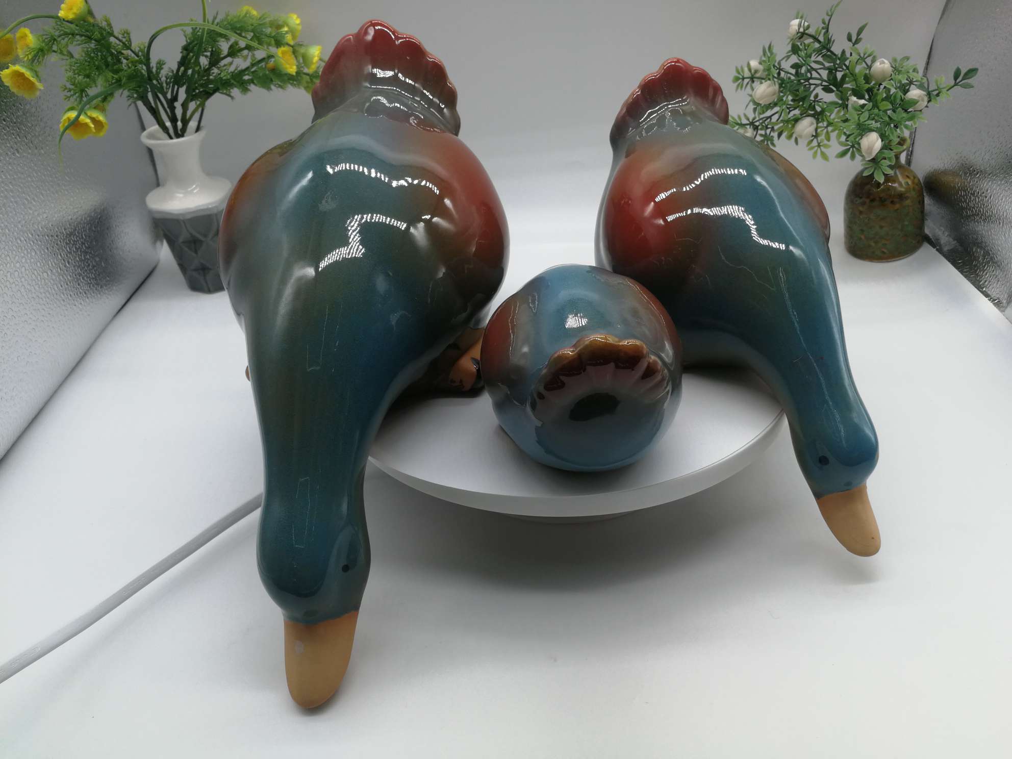 Three water playing duck figurines are available in white, green or blue undefined