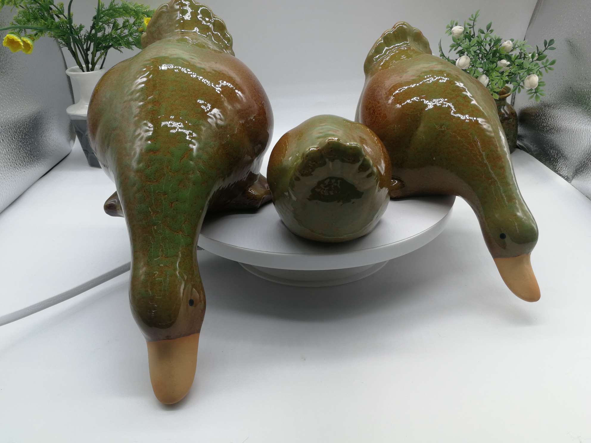 Three water playing duck figurines are available in white, green or blue undefined