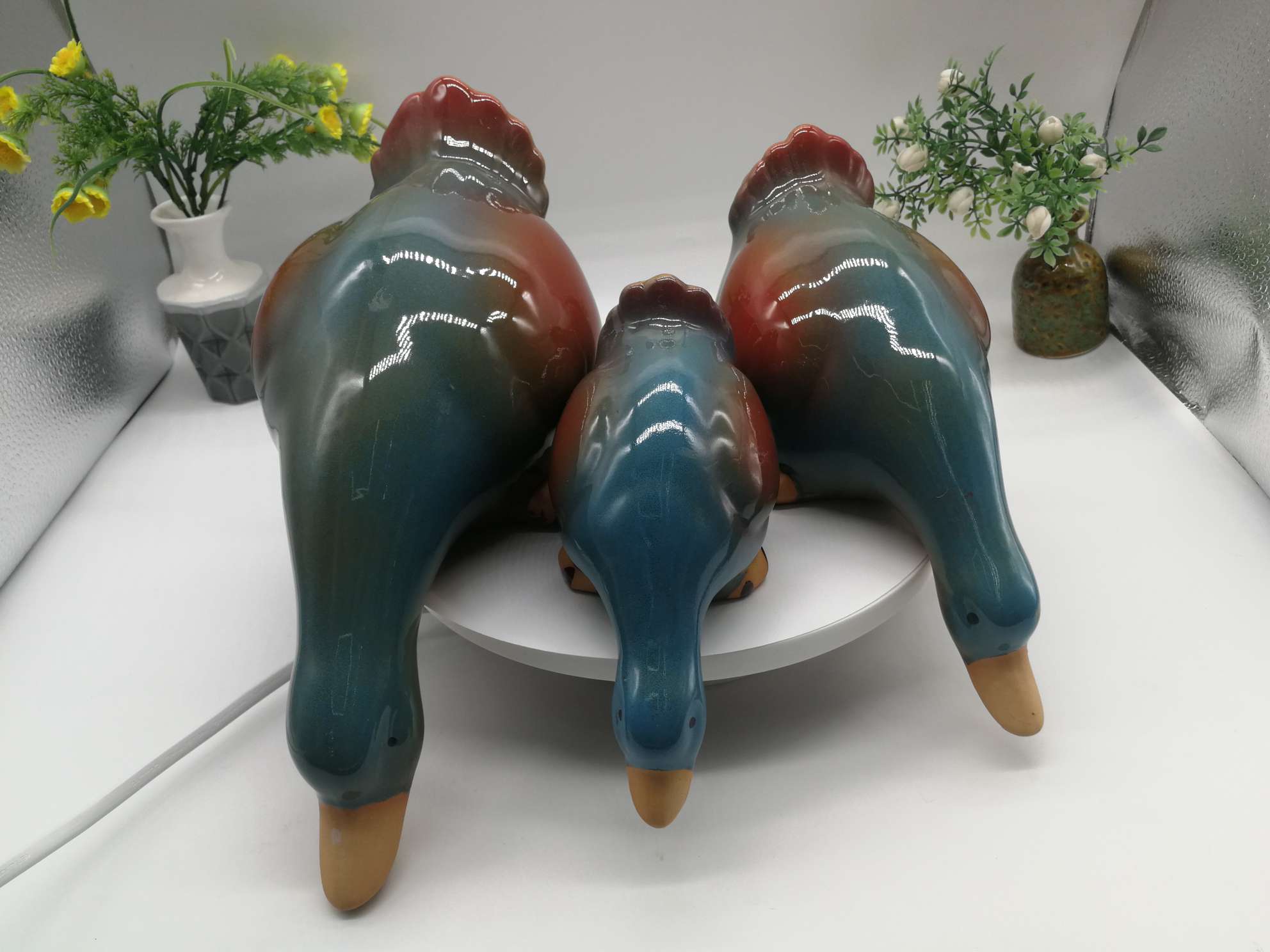 Three water playing duck figurines are available in white, green or blue undefined