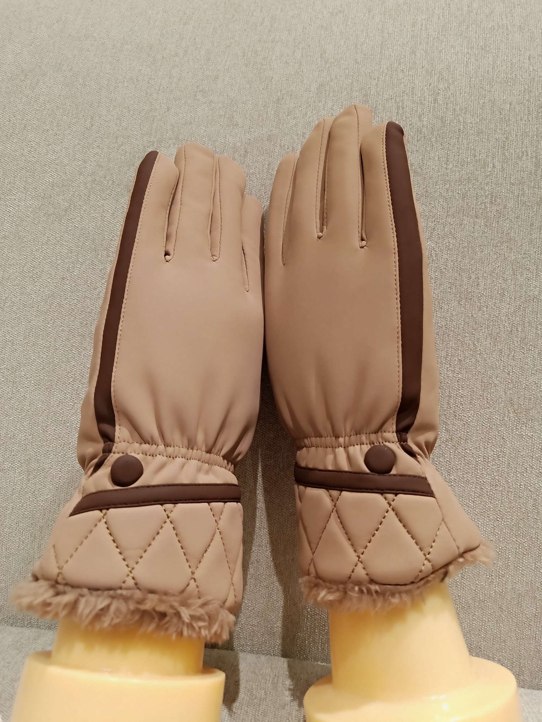 Person wearing skin-sensitive gloves while gardening with fresh flowers nearby