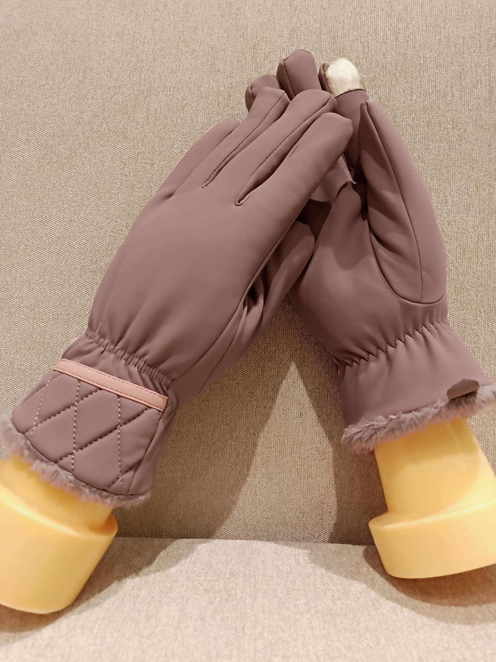 User testimonial moment: woman smiling while wearing gloves and doing laundry