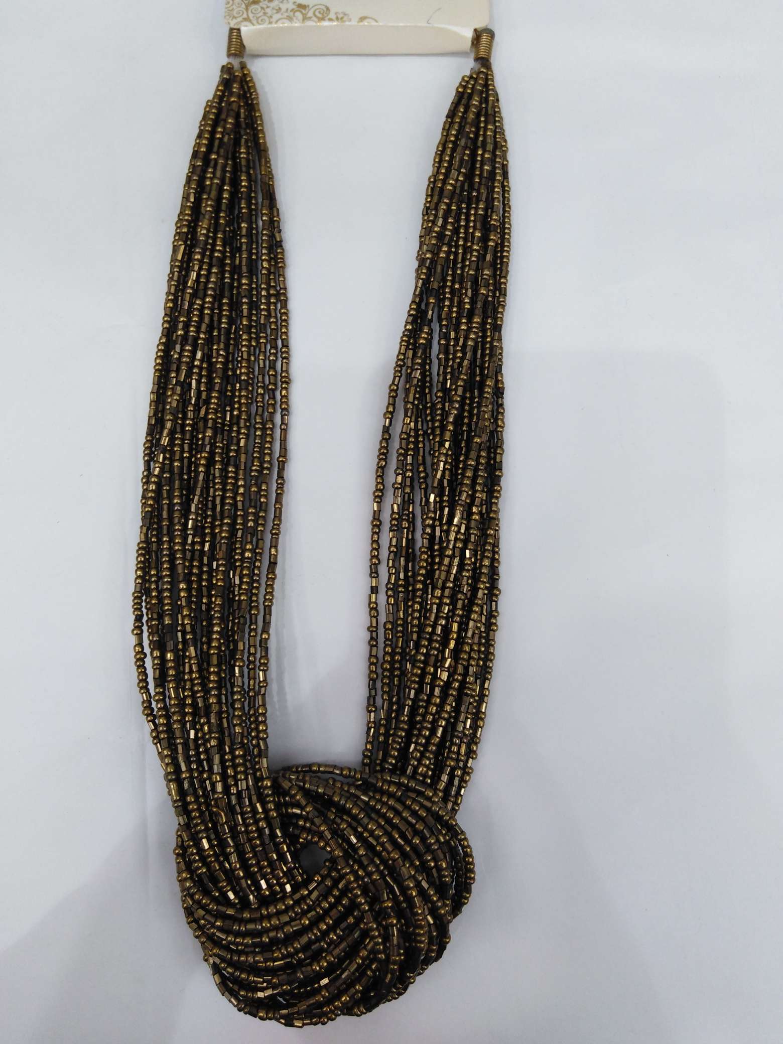 The rice pipe goes through the necklace thumbnail