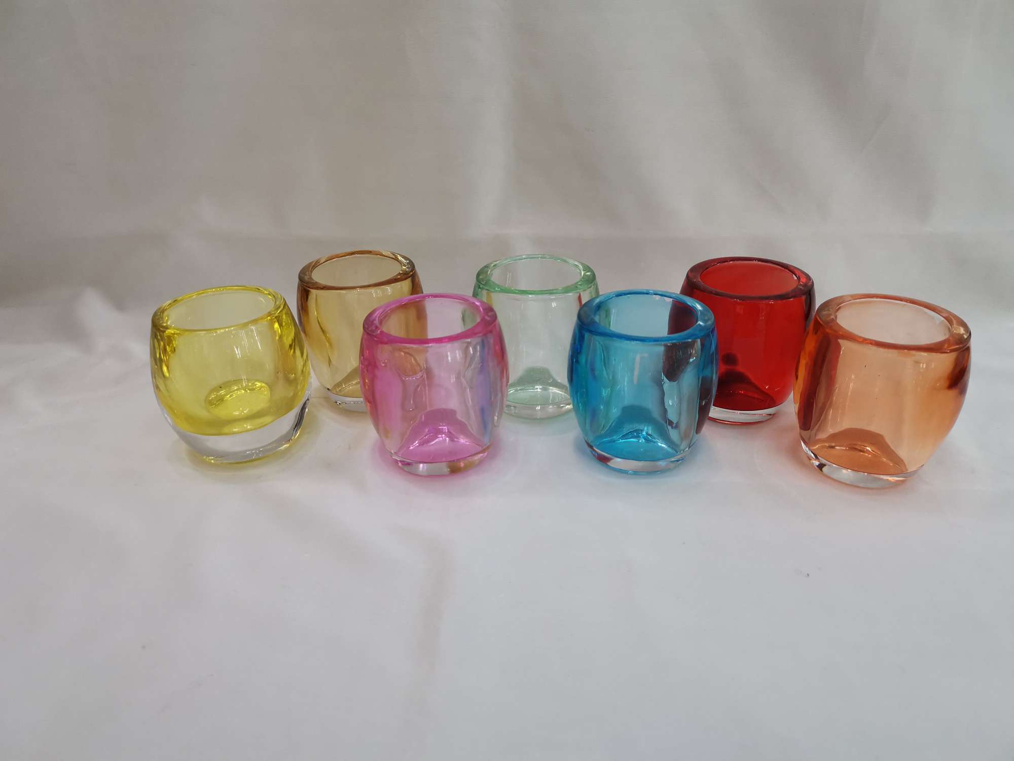 Round drum-shaped glass colored candlestick