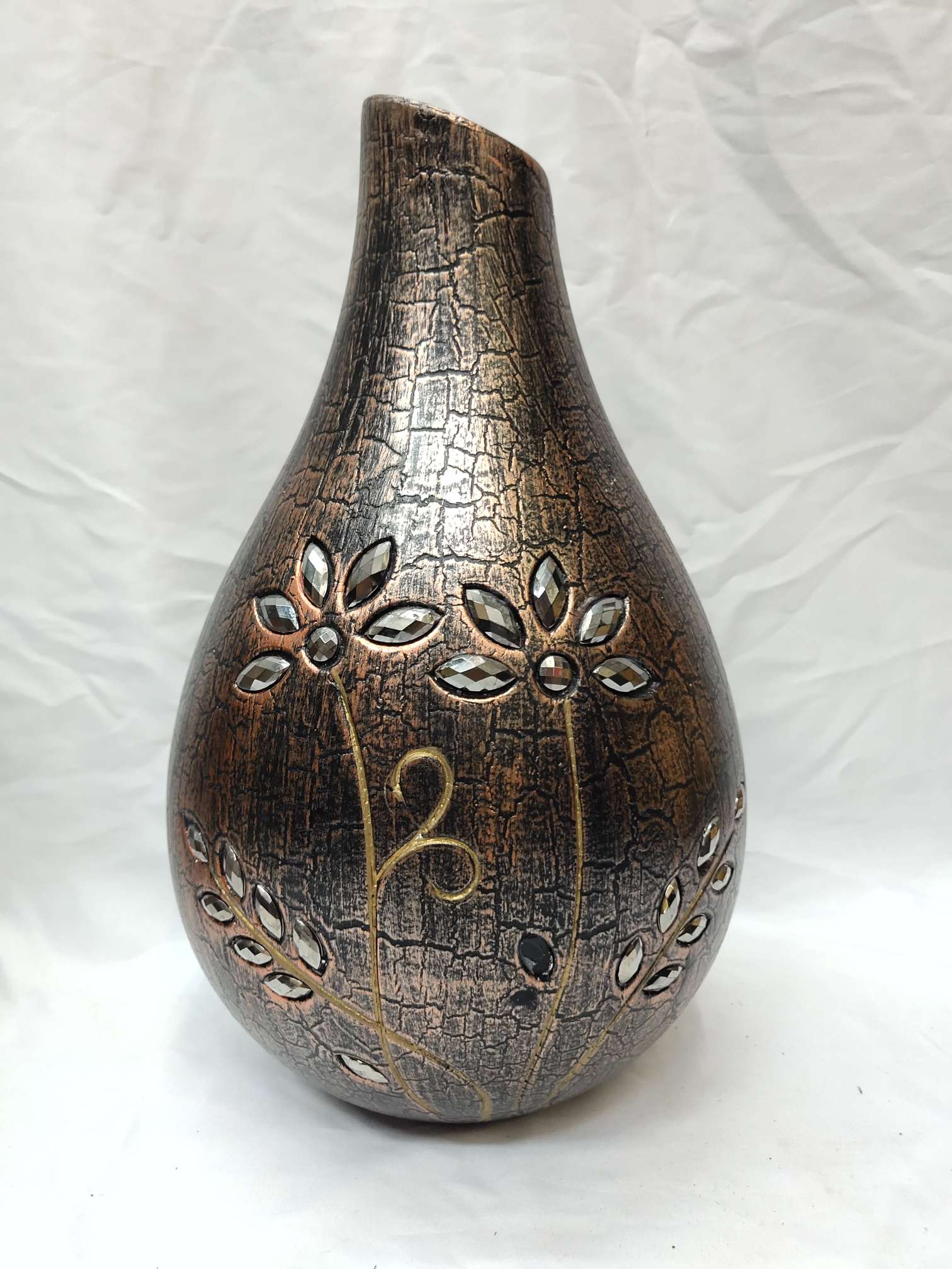 A diamond-encrusted vase with a closed mouth and a large belly