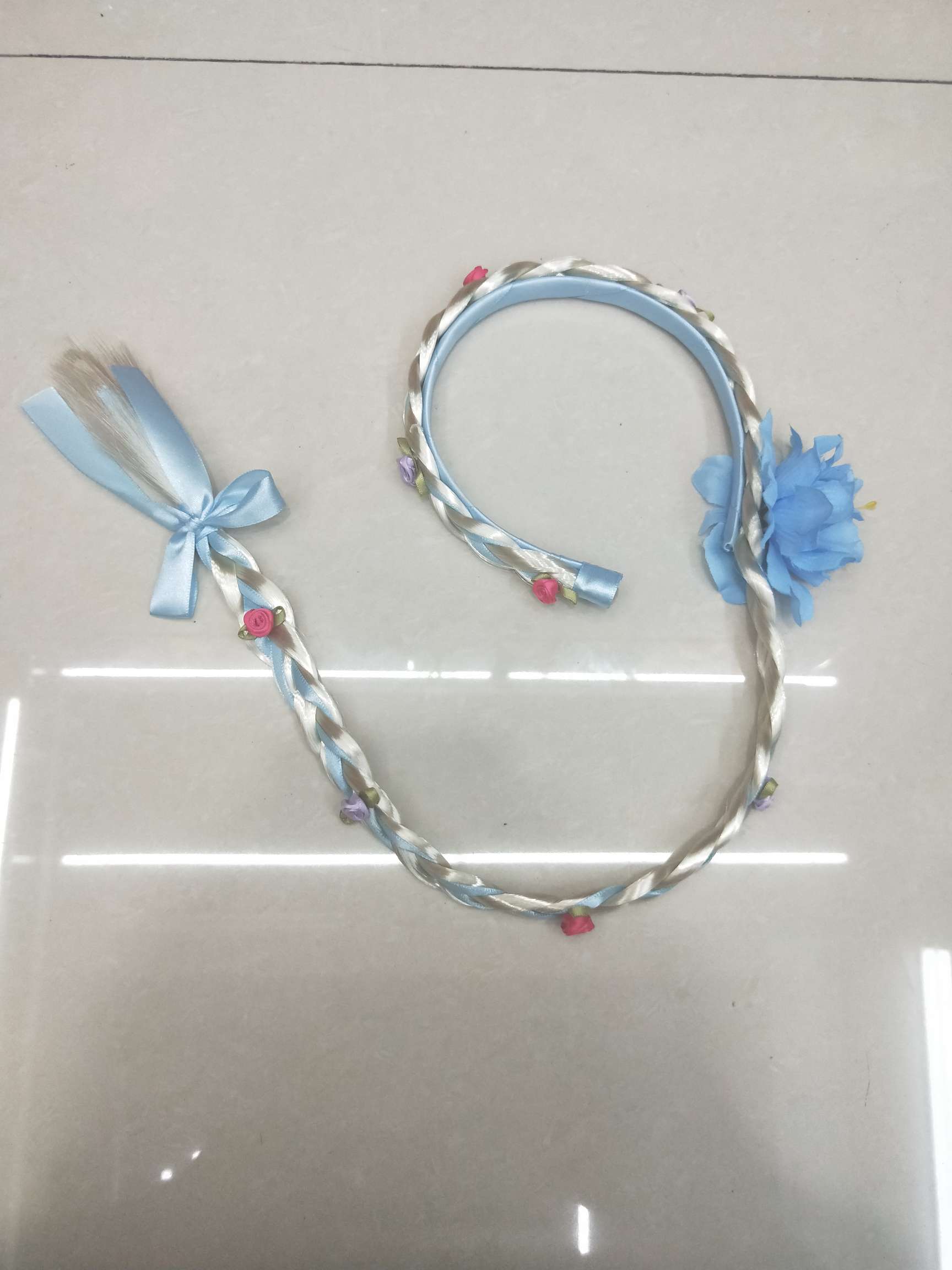 Long braids with ribbon-sized flower bows