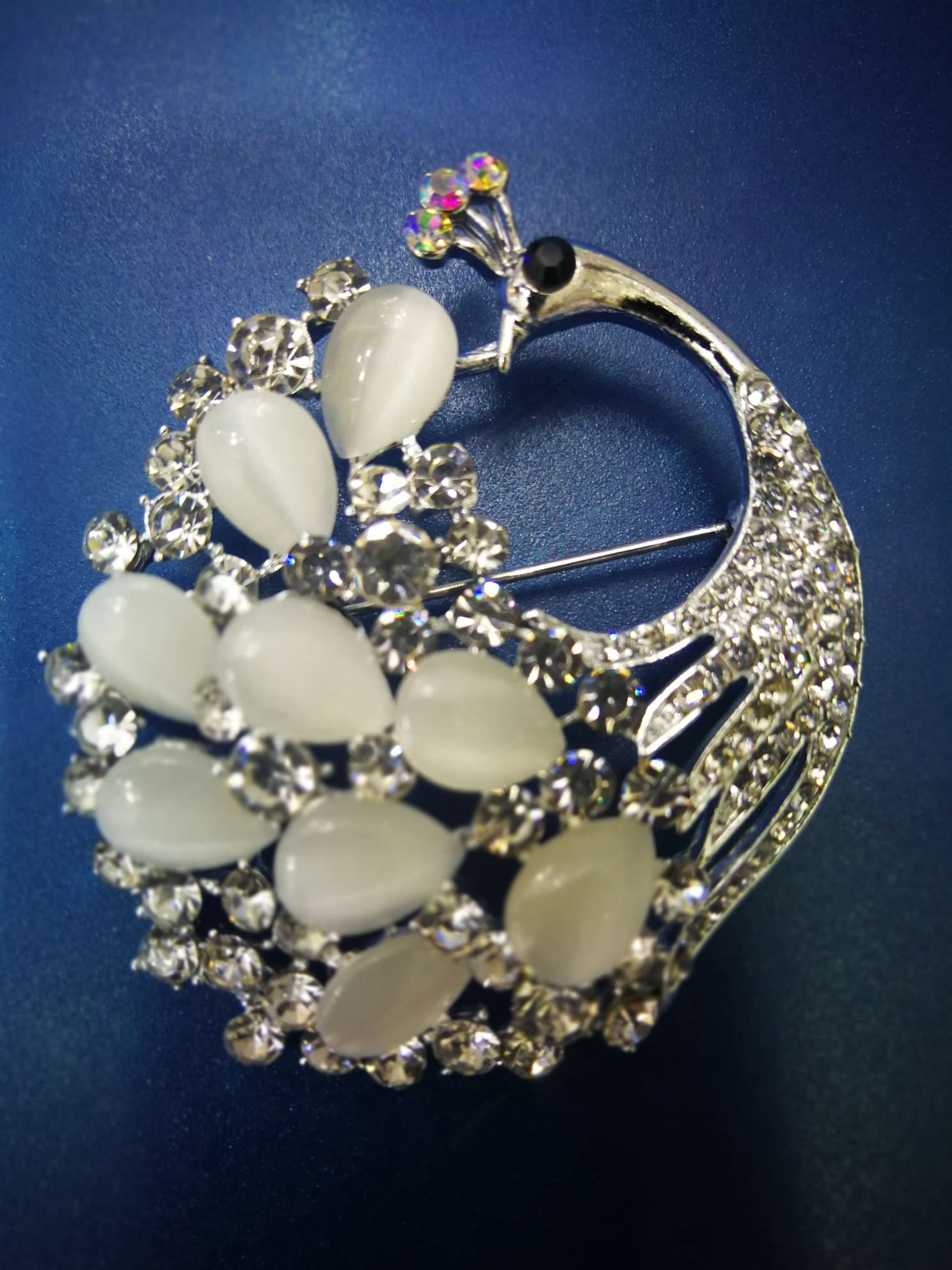 Cat's eye peacock brooch