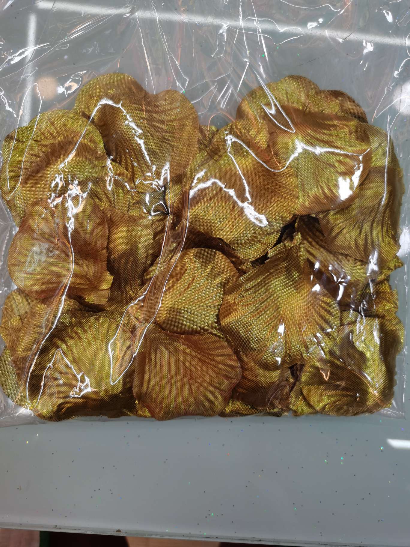 Simulated rose petal wedding decoration in gold