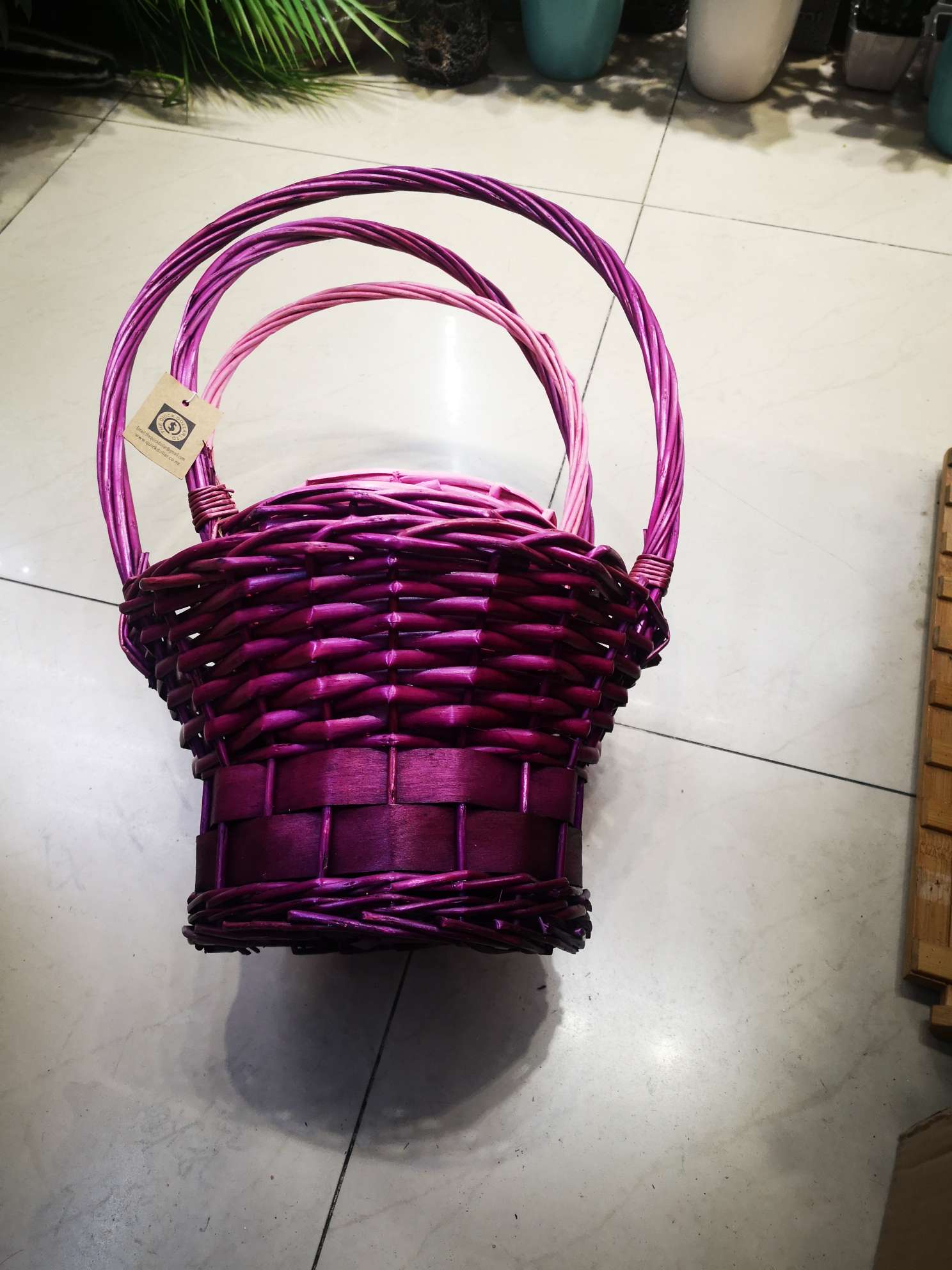 The purple hand-held basket for flower arrangement