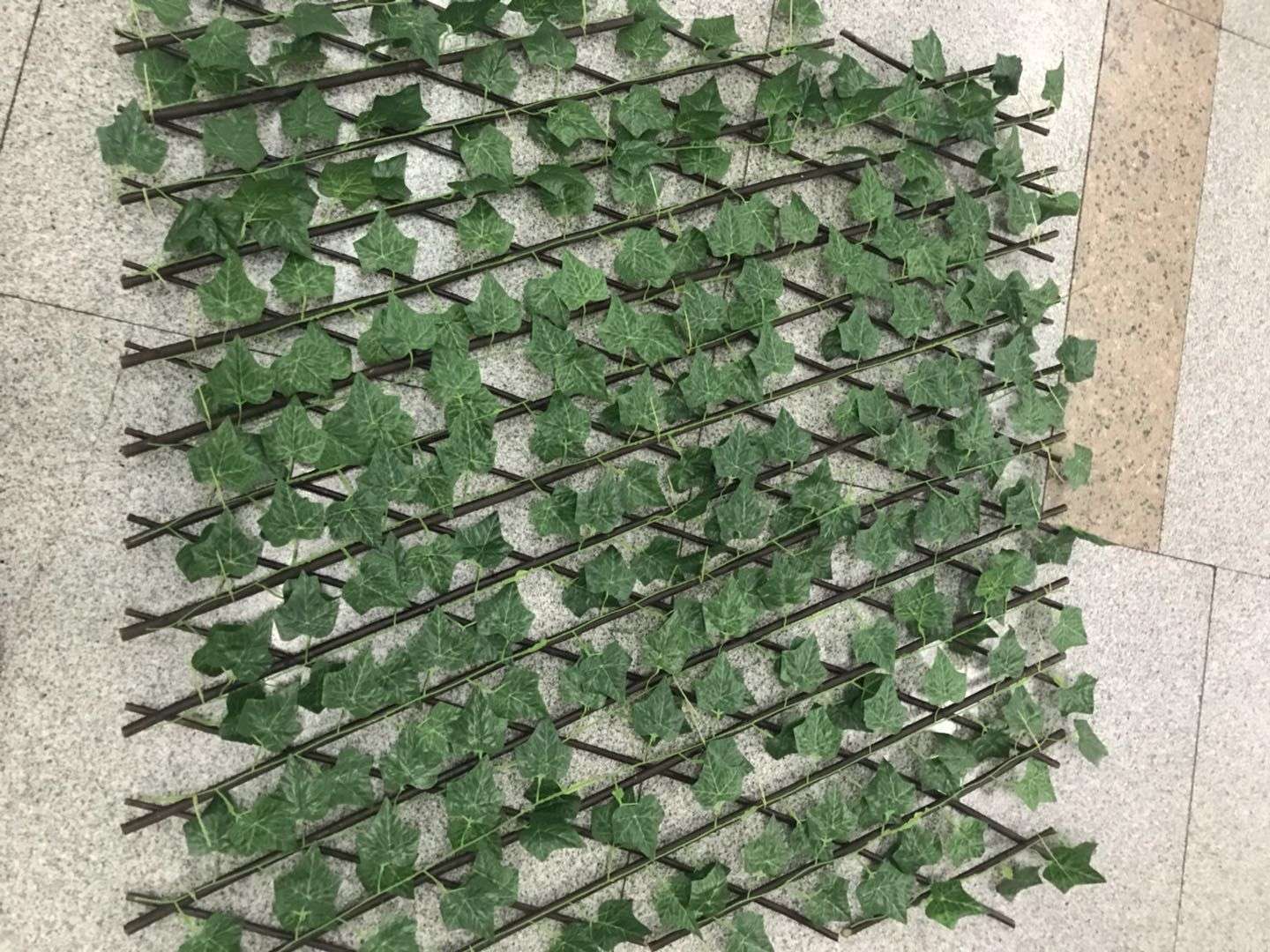 A fine decorative artificial plant, the fence with large leaves