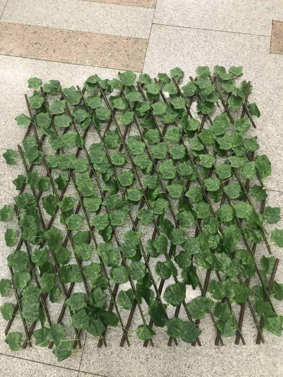 A fine decorative artificial plant, the fence with large leaves Specification image
