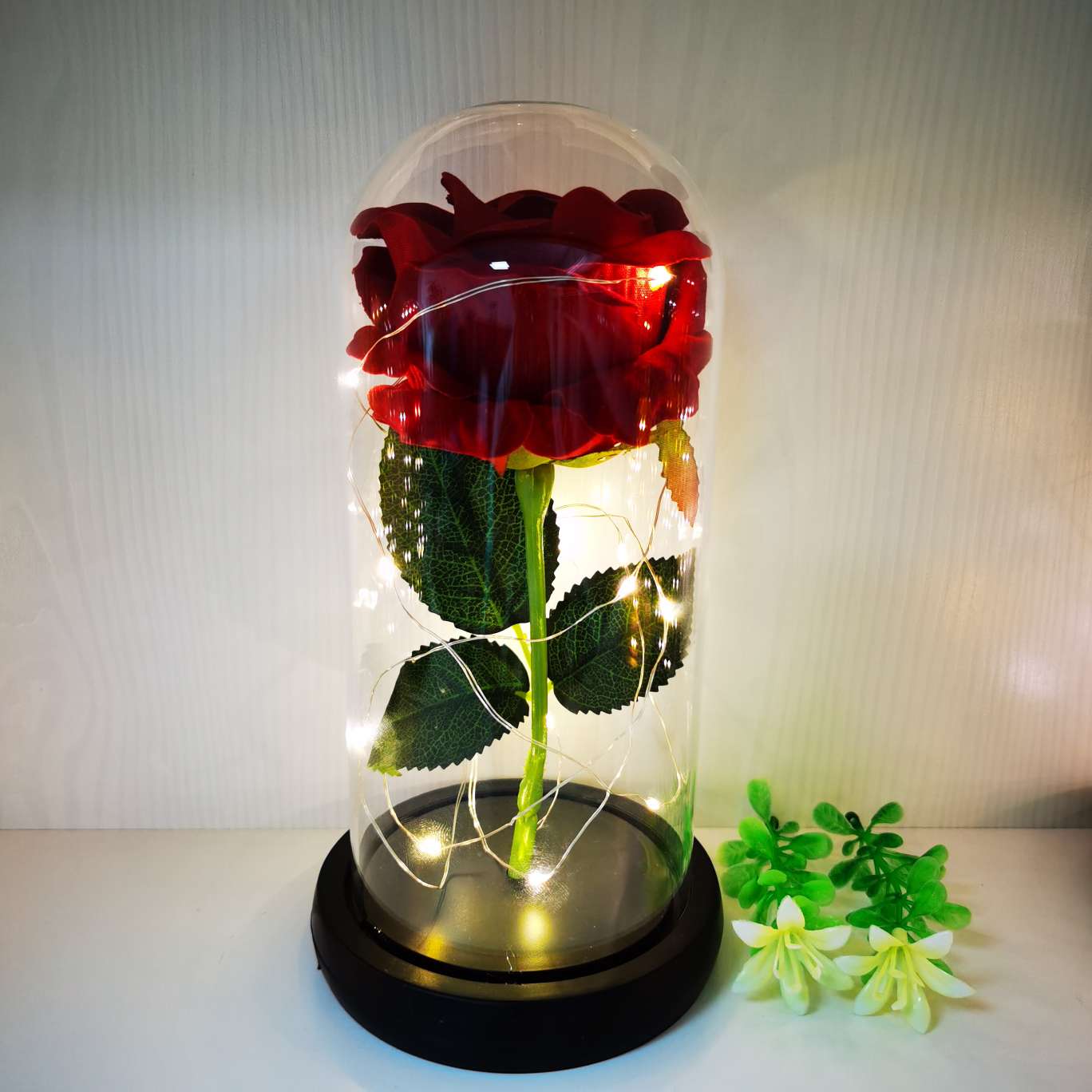 A silk flower ornament with a glass cover undefined