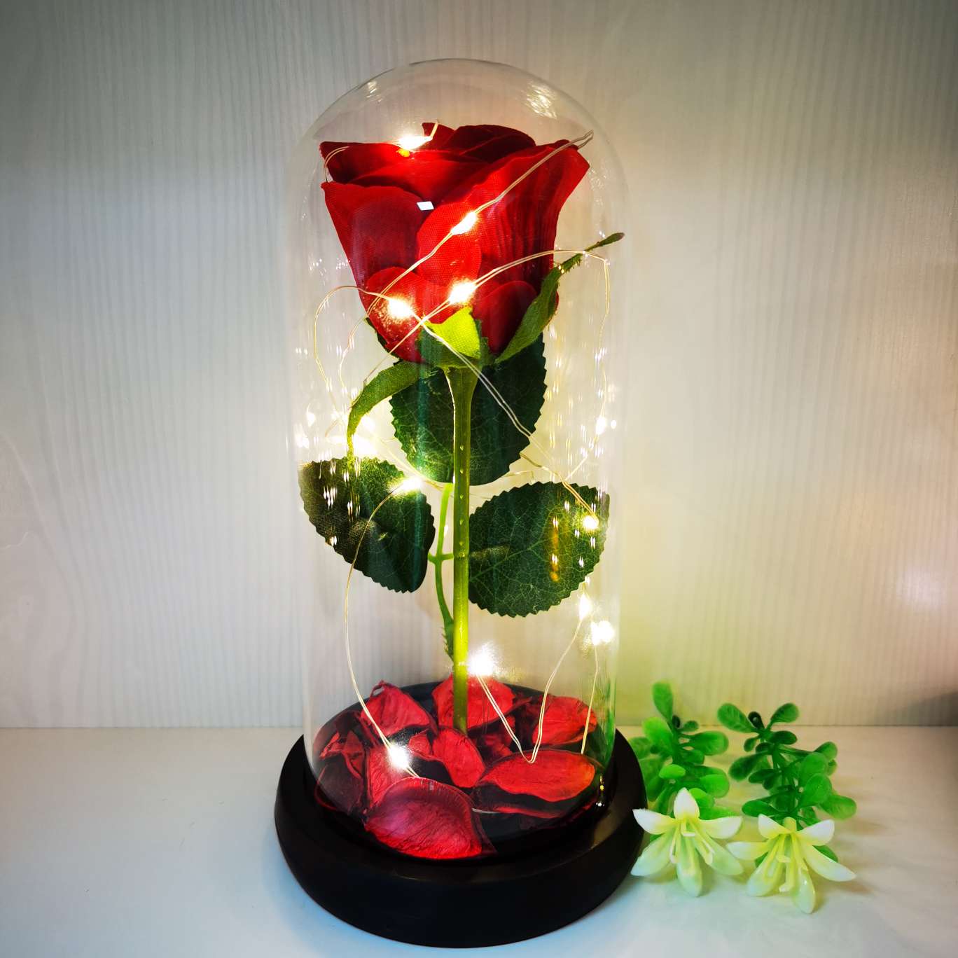 A silk flower ornament with a glass cover Item Picture
