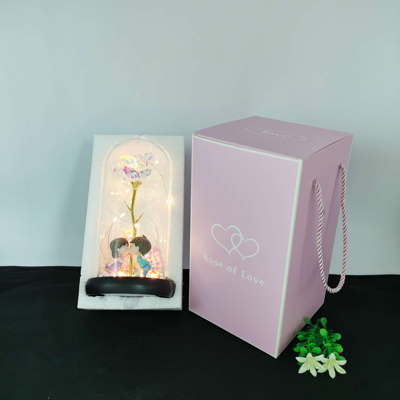 A silk flower ornament with a glass cover undefined