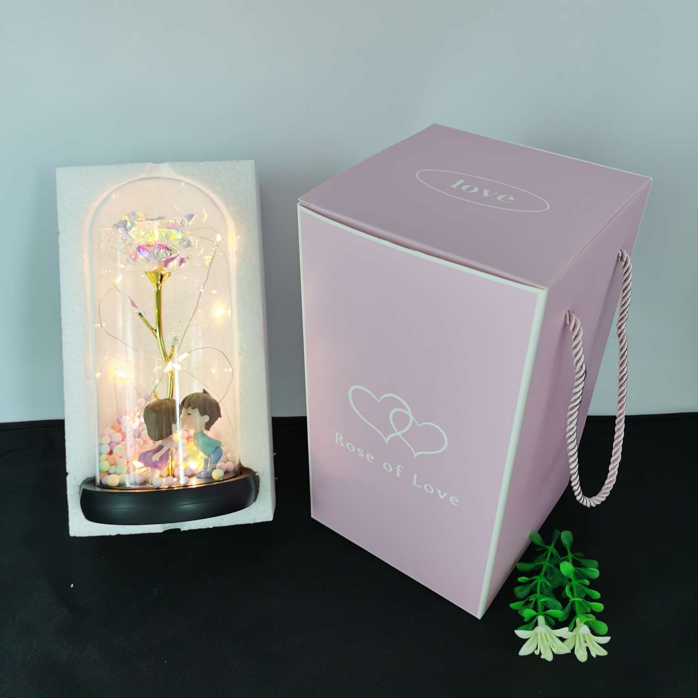 A decorative item with a glass cover and a solid wood base, featuring golden rose petals undefined