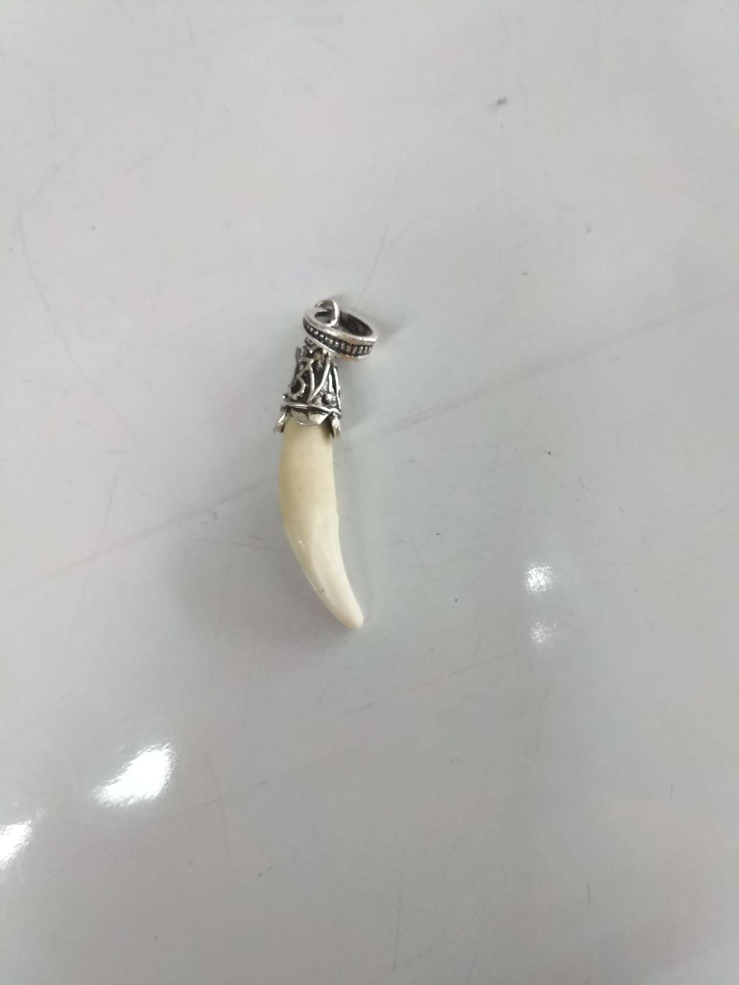 Tibetan pattern small white dog teeth spike pendant inlaid braces really black dog teeth for men and women pendant. thumbnail