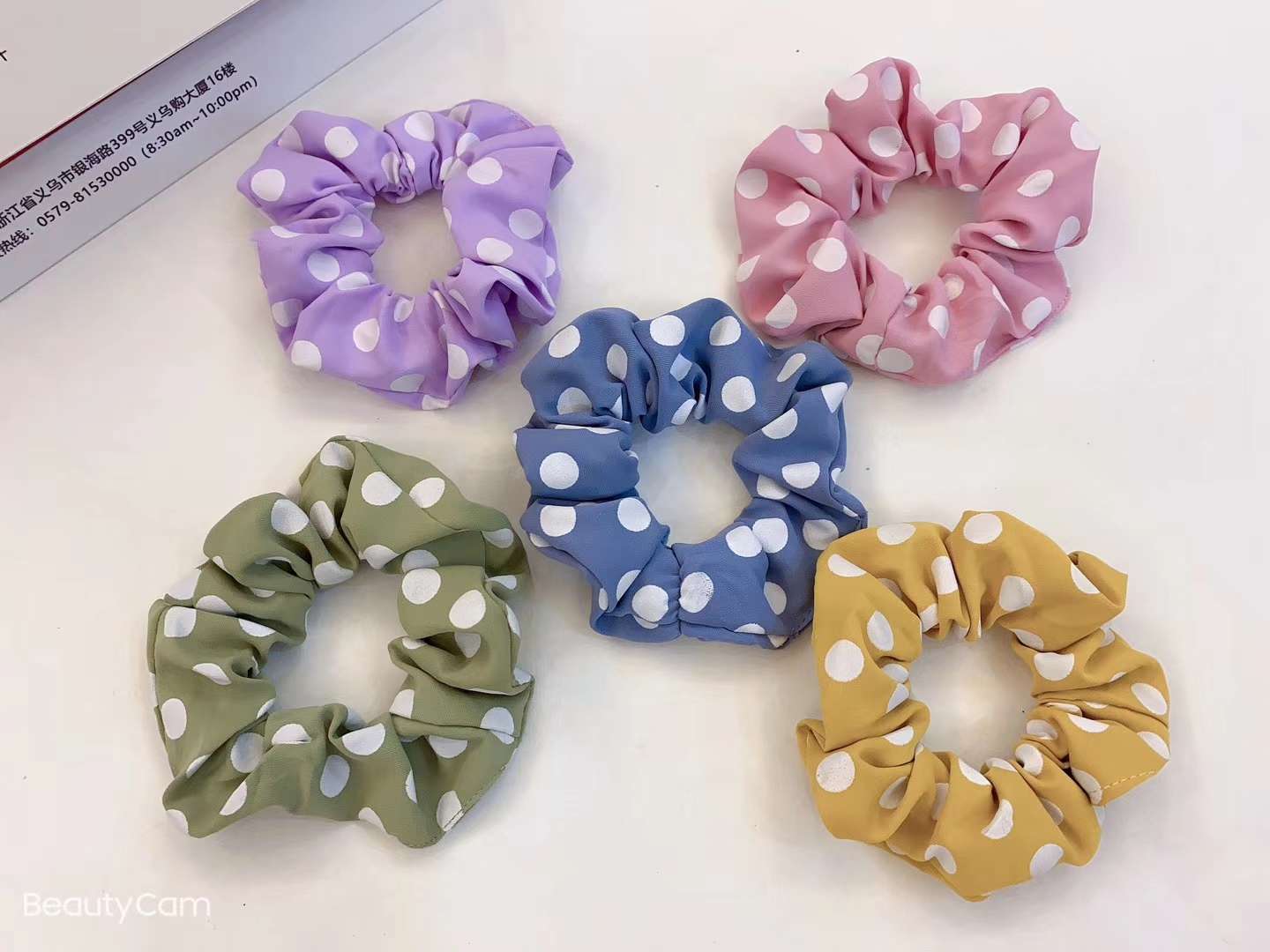 A single-color white polka dot large intestine ring