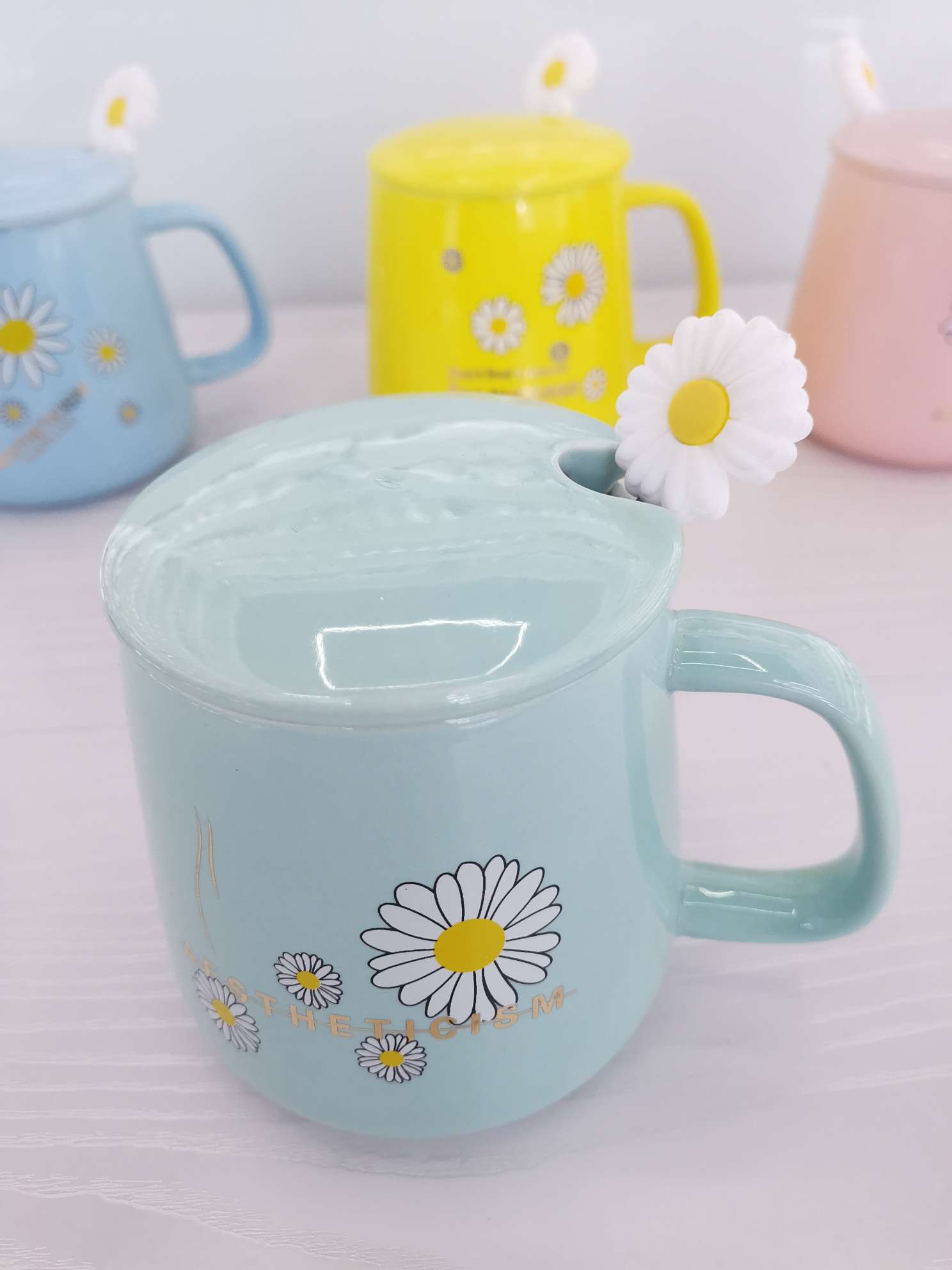 Fresh chrysanthemum-colored glazed ceramic mugs, coffee cups and water cups undefined