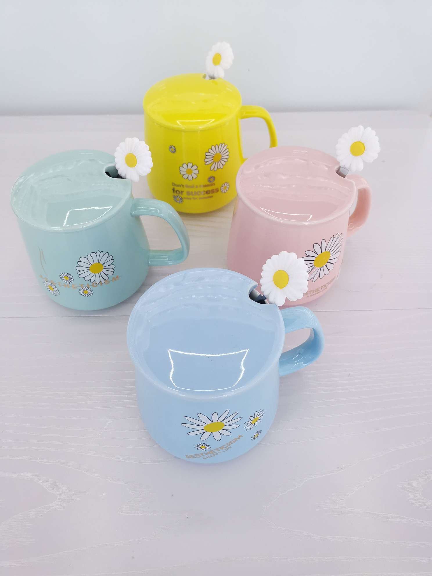 Fresh chrysanthemum-colored glazed ceramic mugs, coffee cups and water cups undefined