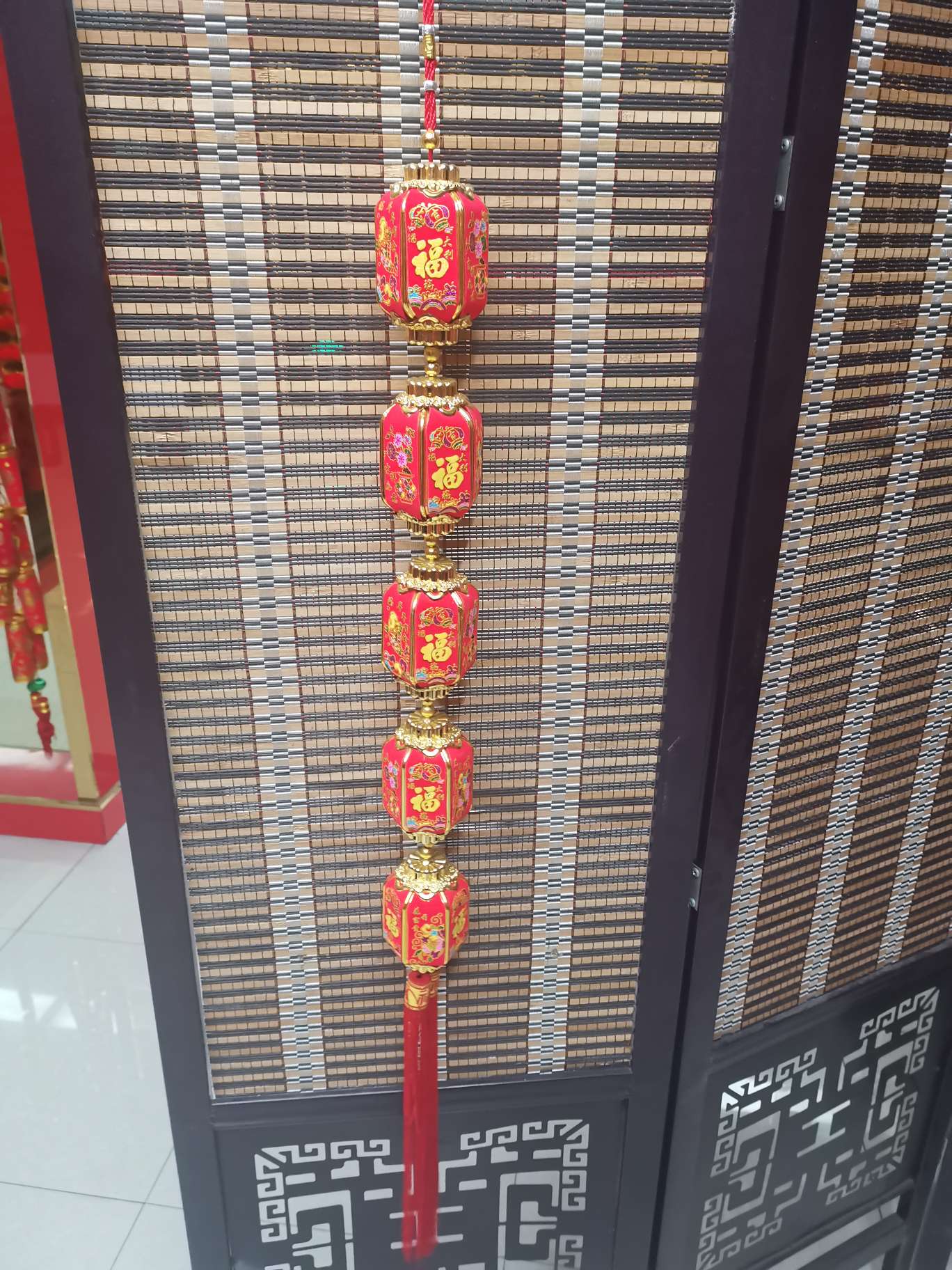 Five small, long, hexagonal lanterns with printed patterns