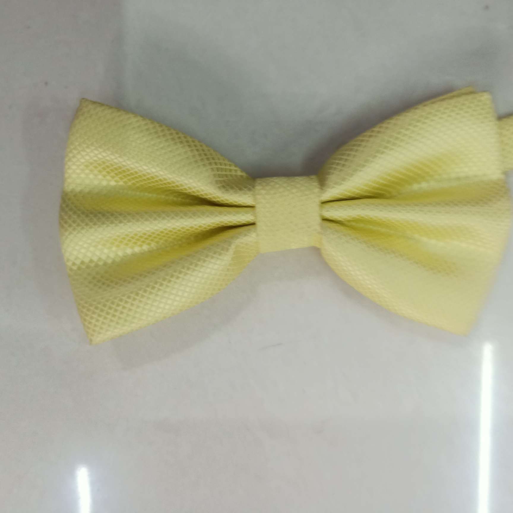 The small checkered bow tie is light yellow details Picture