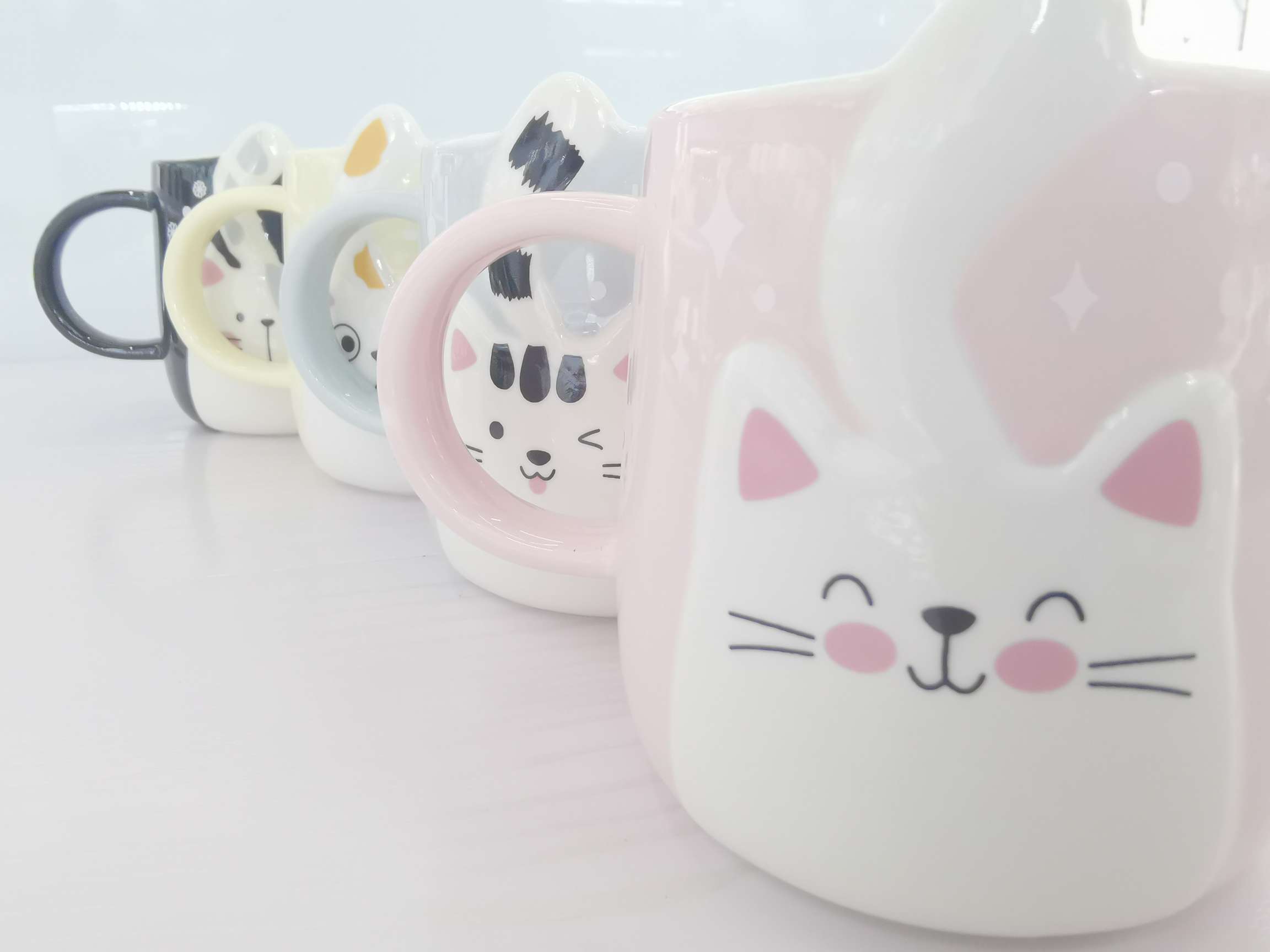 Cute cat-shaped colored glazed ceramic cups, coffee cups and water cups undefined