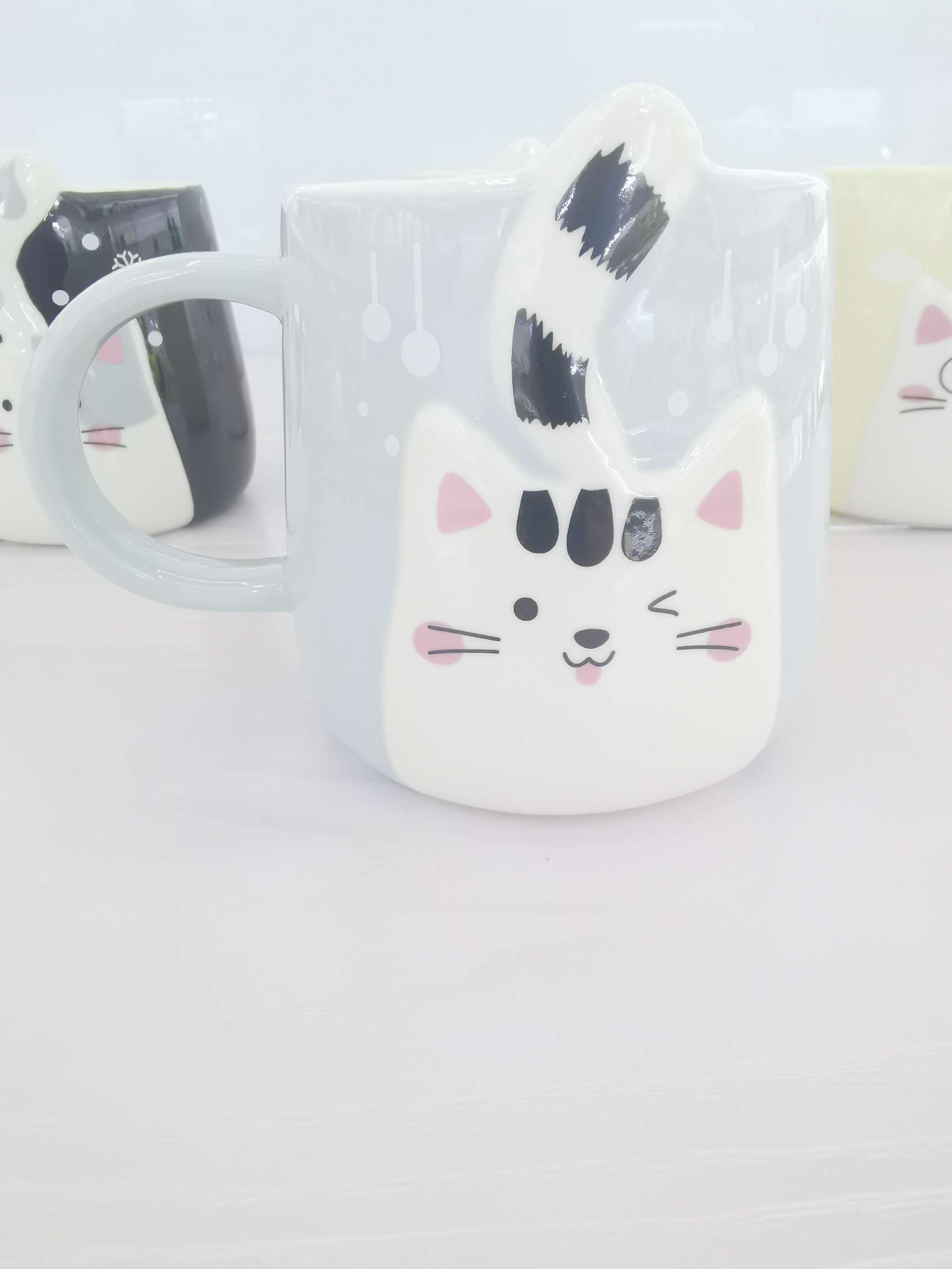 Cute cat-shaped colored glazed ceramic cups, coffee cups and water cups undefined