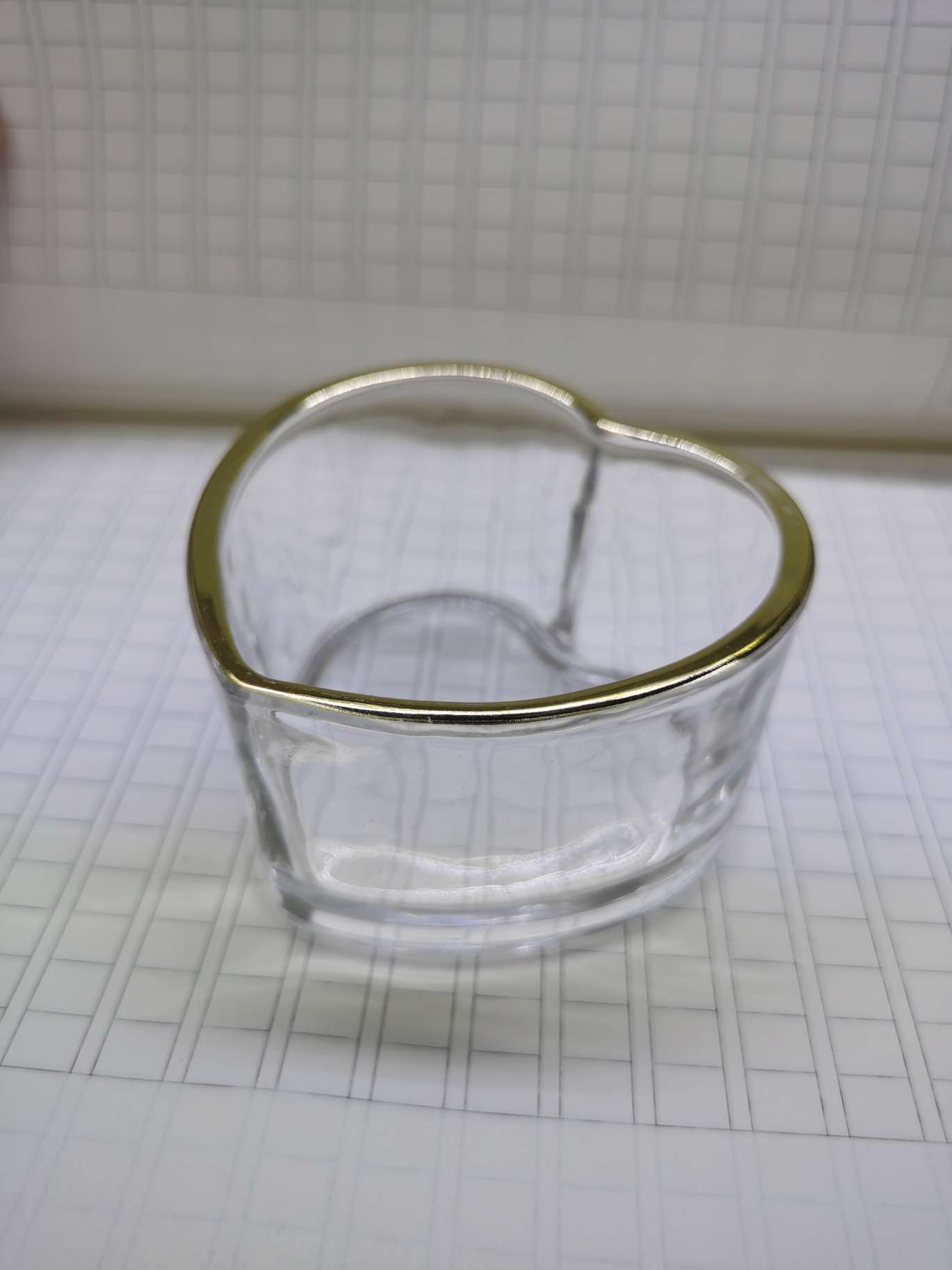 Small glass bowl with gold edge and heart