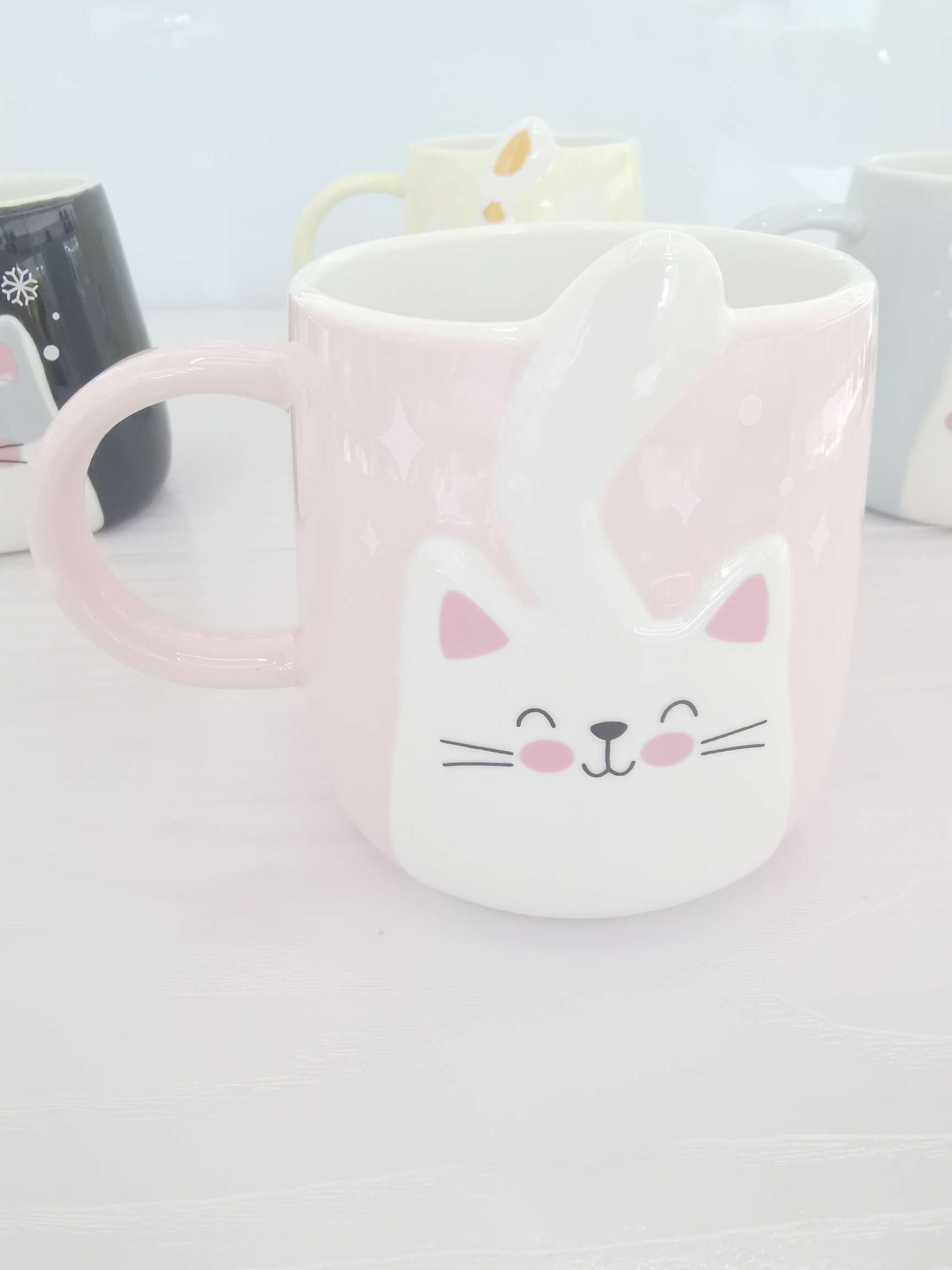 Cute cat-shaped colored glazed ceramic cups, coffee cups and water cups undefined
