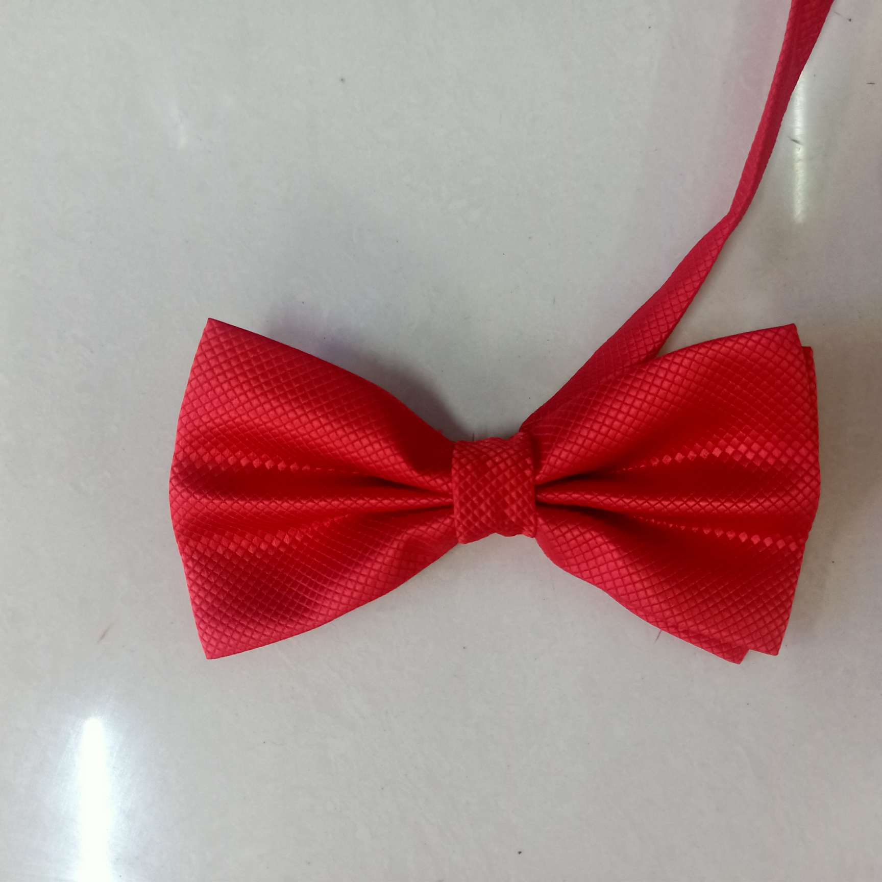 The small checkered bow tie is bright red details Picture