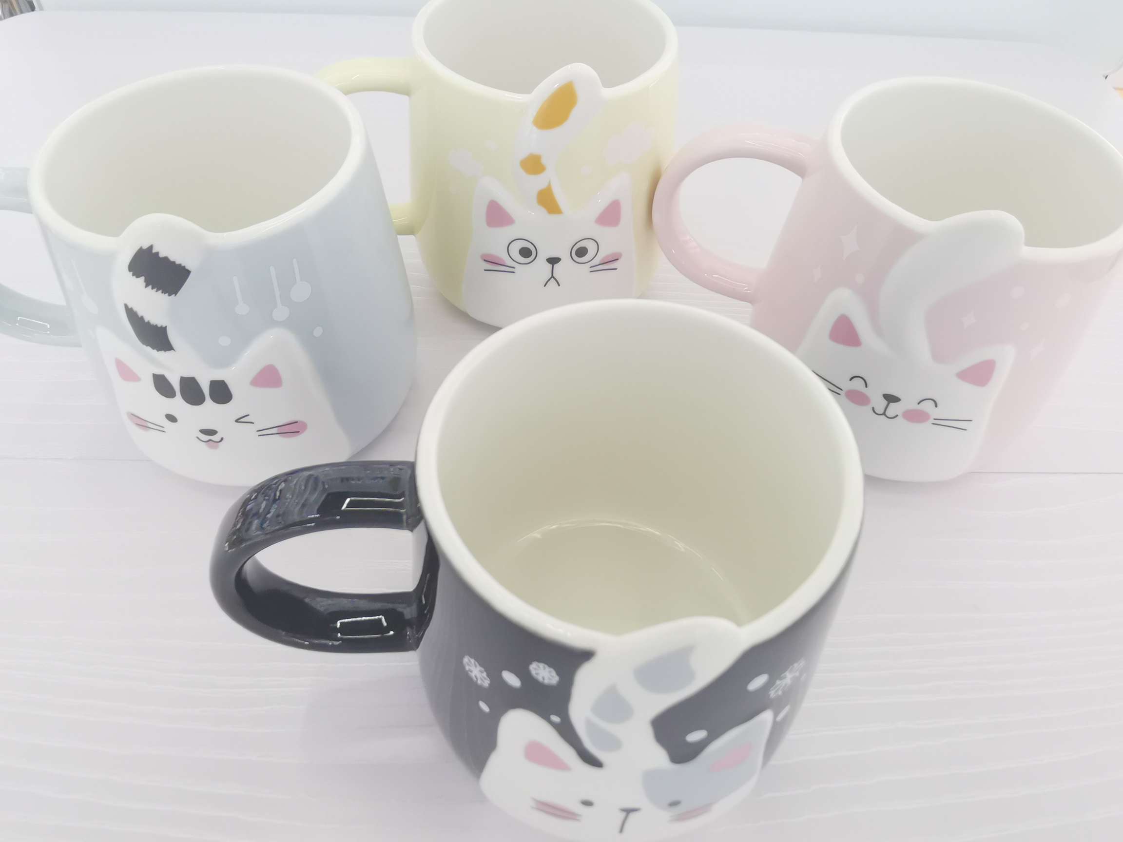 Cute cat-shaped colored glazed ceramic cups, coffee cups and water cups undefined