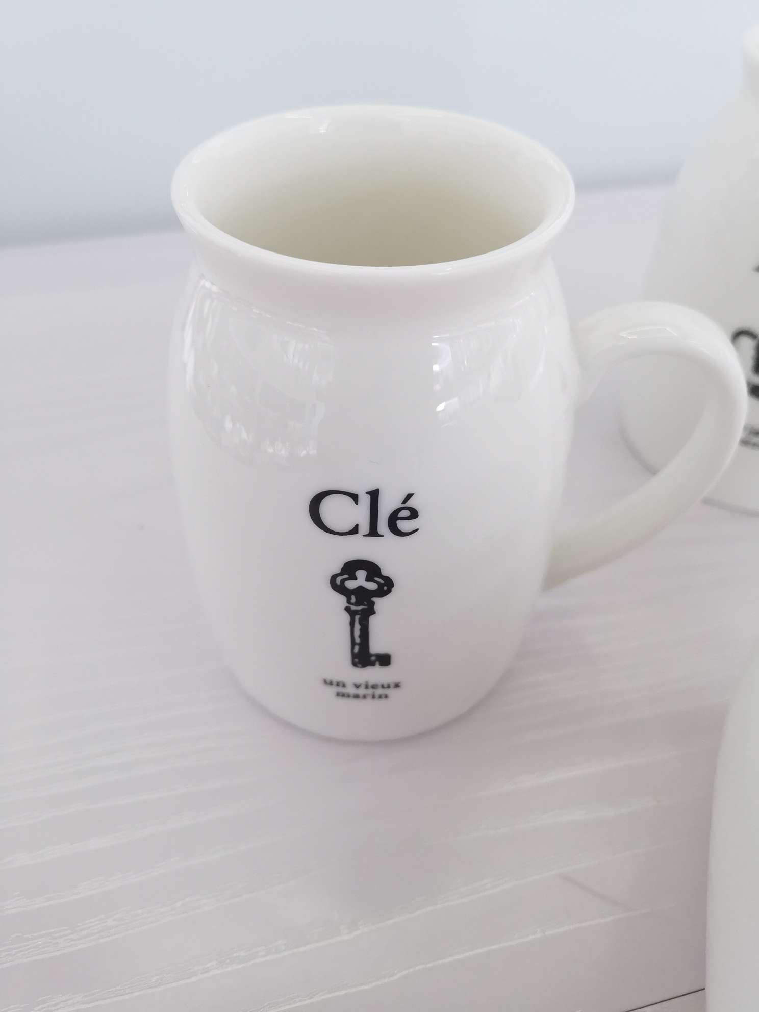 Simple white glossy ceramic milk cups and water cups undefined