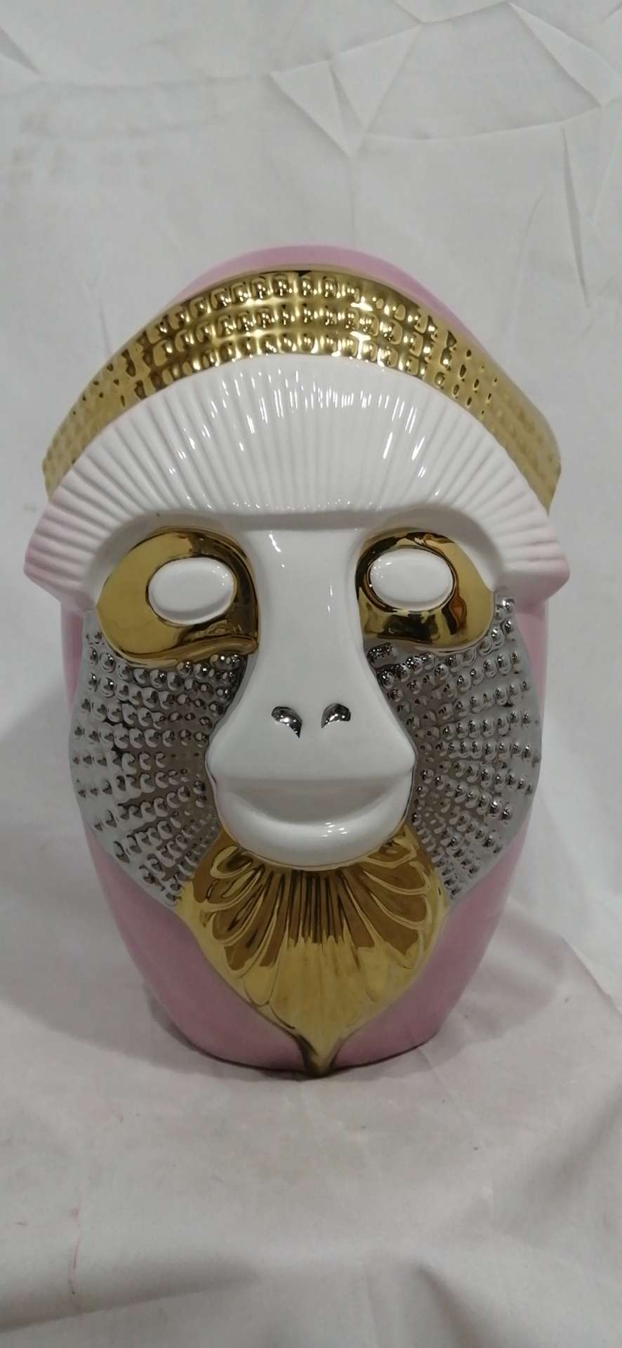The ceramic monkey-face bottle is 35 cm tall