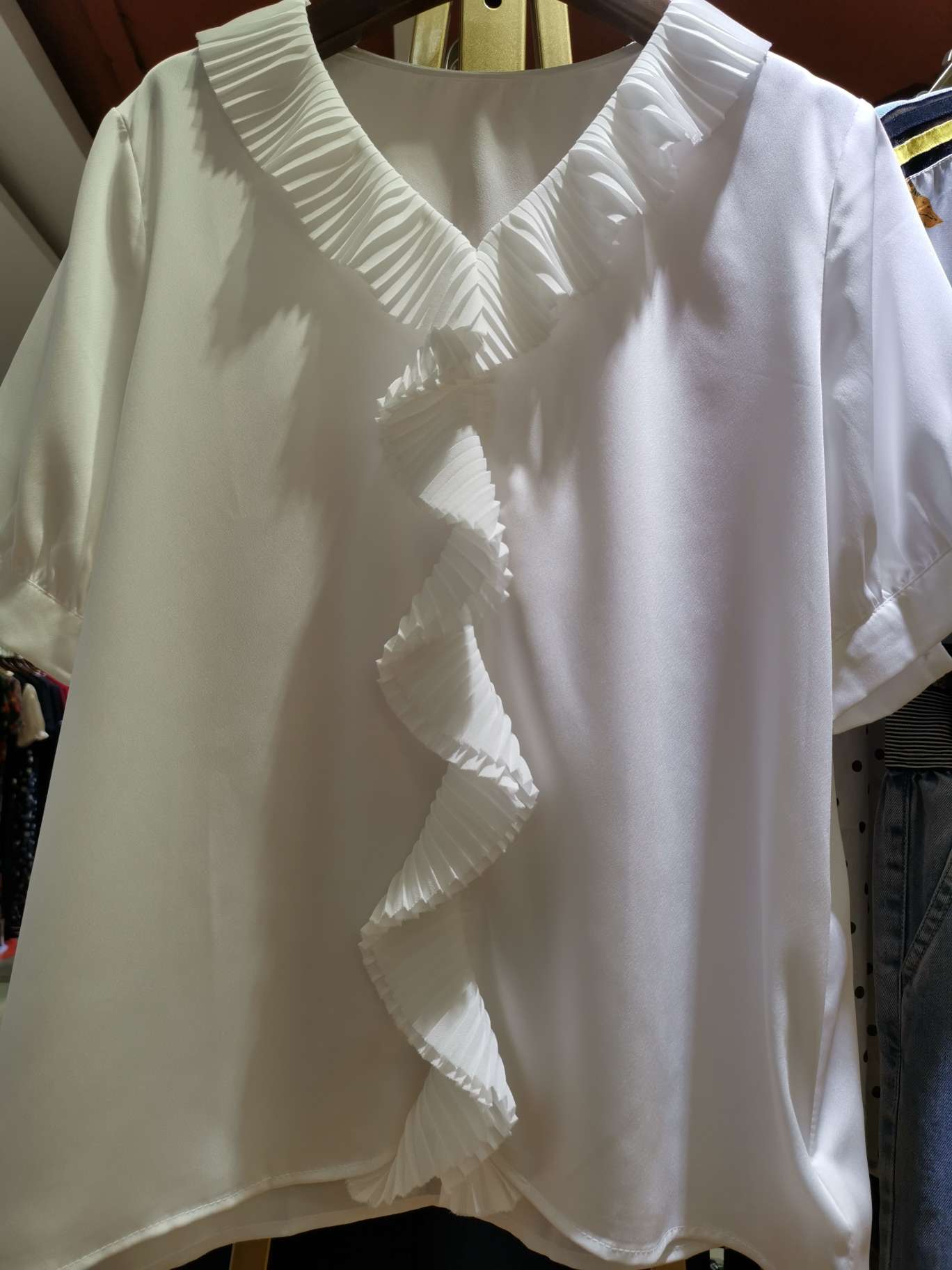 A fashionable women's top with a large lace V-neck