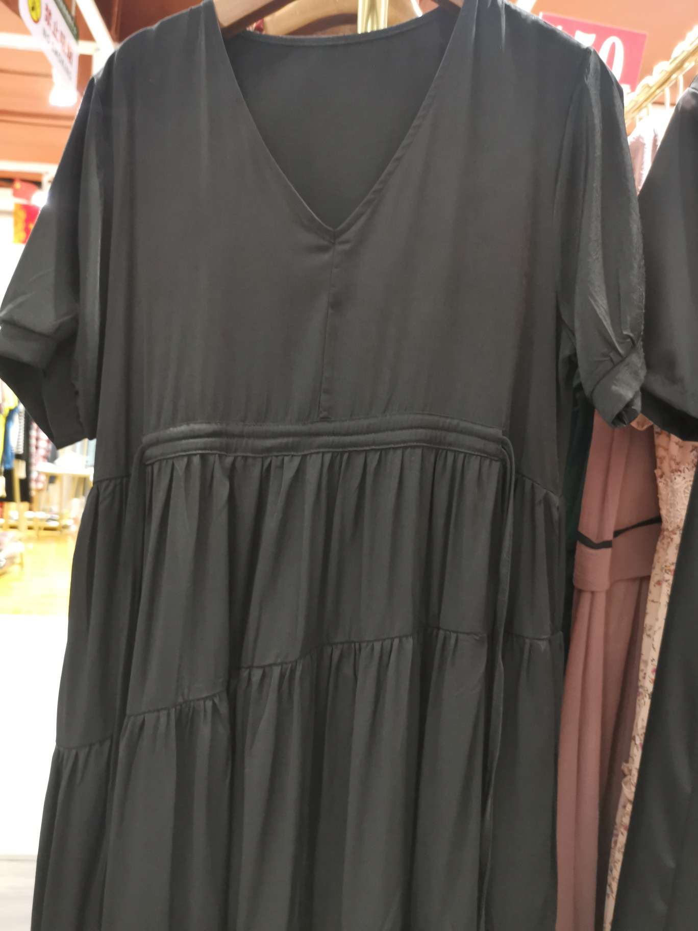 A fashionable black loose women's dress with a large V-neck