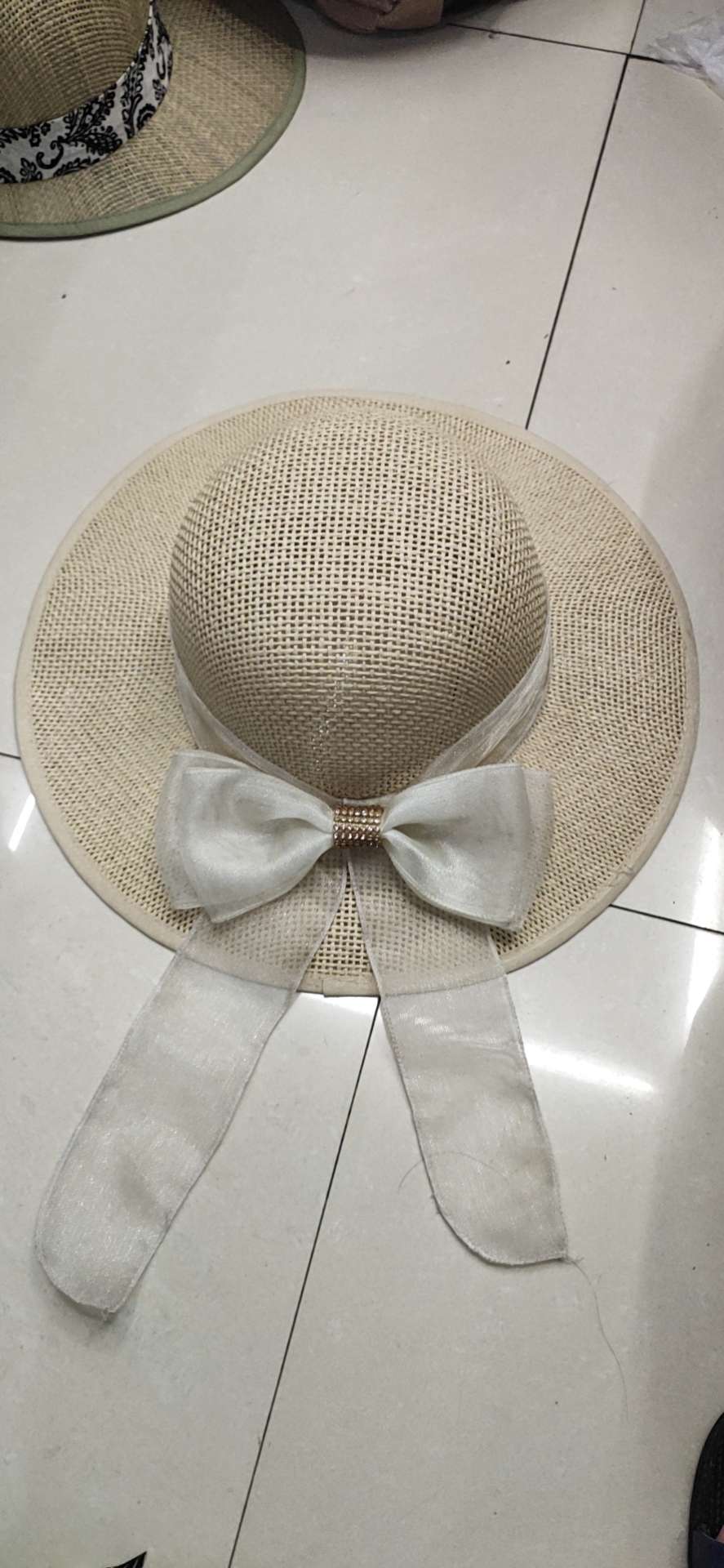 Paper and cloth bow-tied wide-brimmed hat