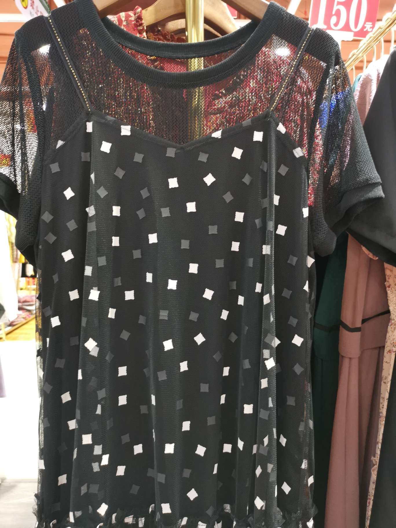 A fashionable halter top reveals a double-layered dress