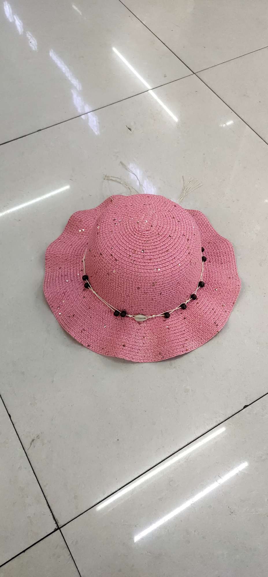 A children's hat with sequined beaded wavy edges