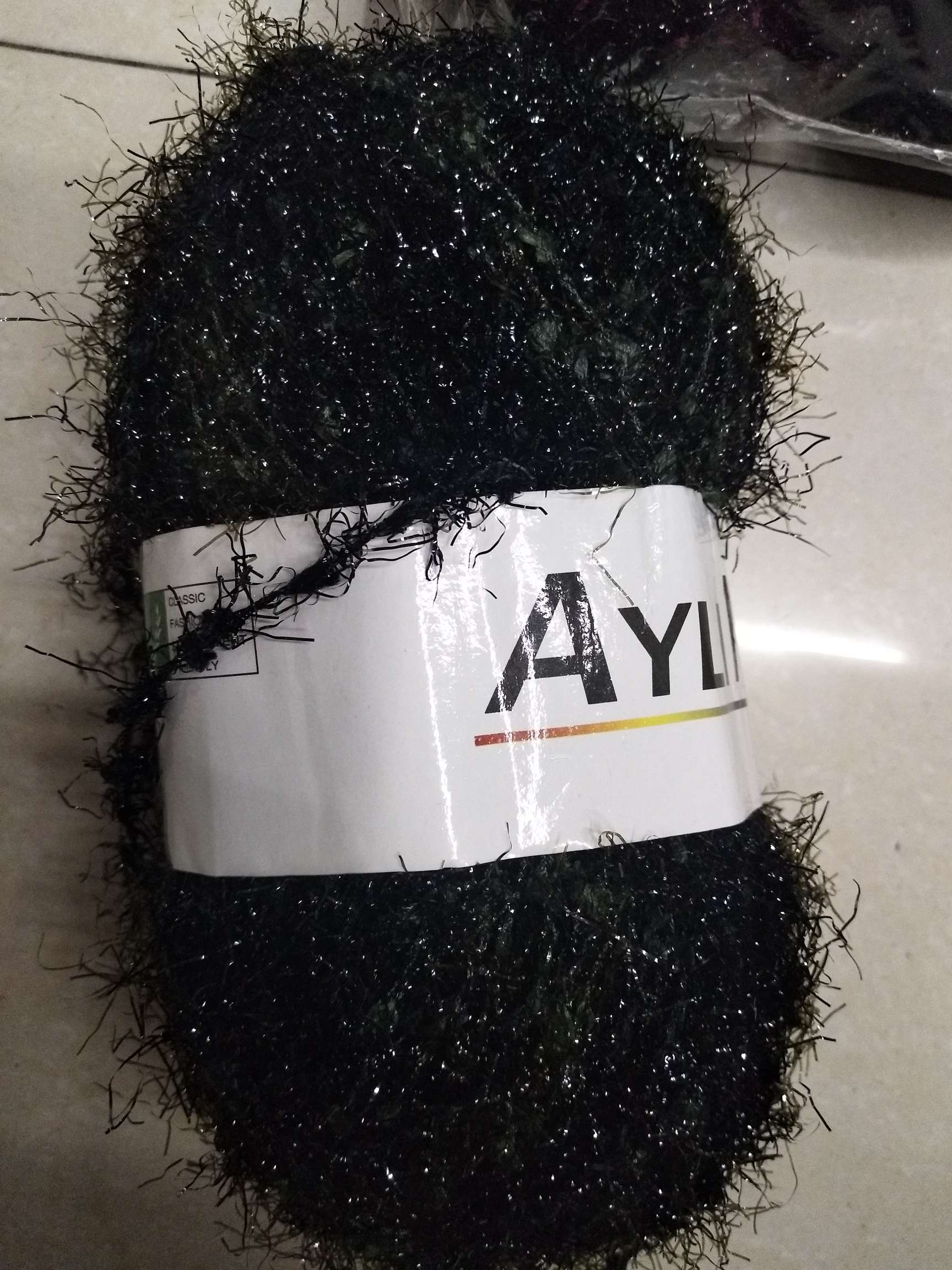 Black water wool and red flag yarn are combined