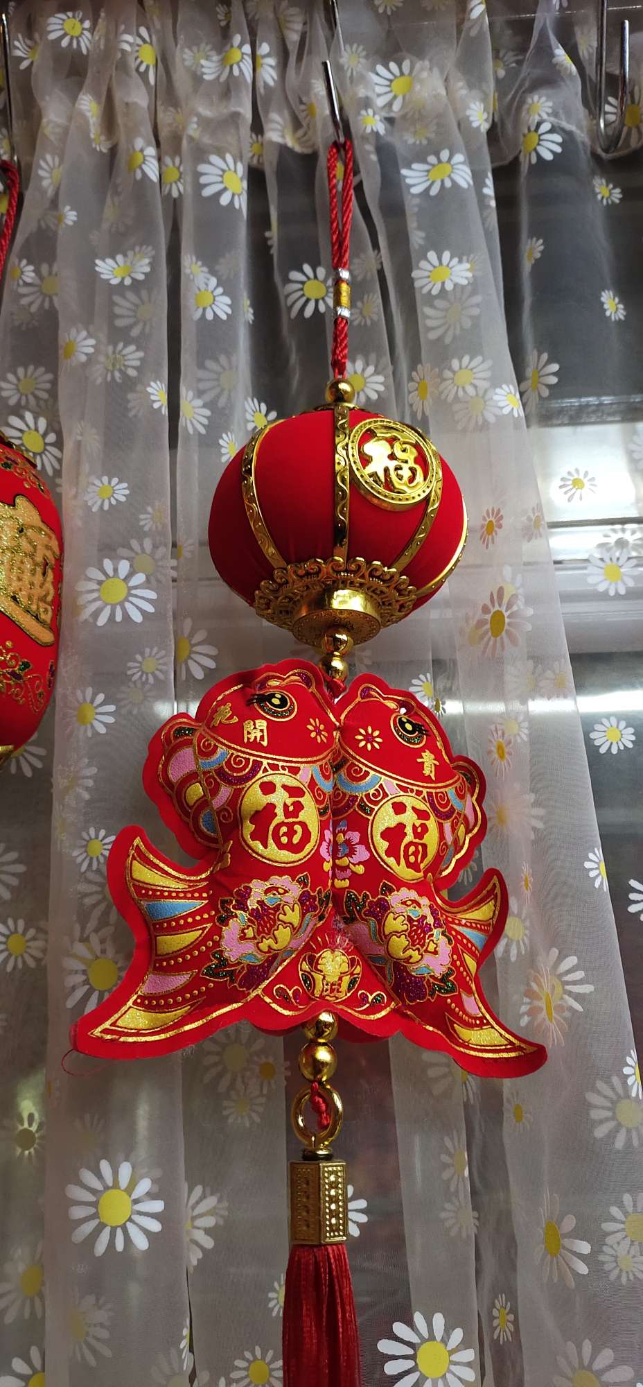 Gilt lanterns hang strings of fish thumbnail