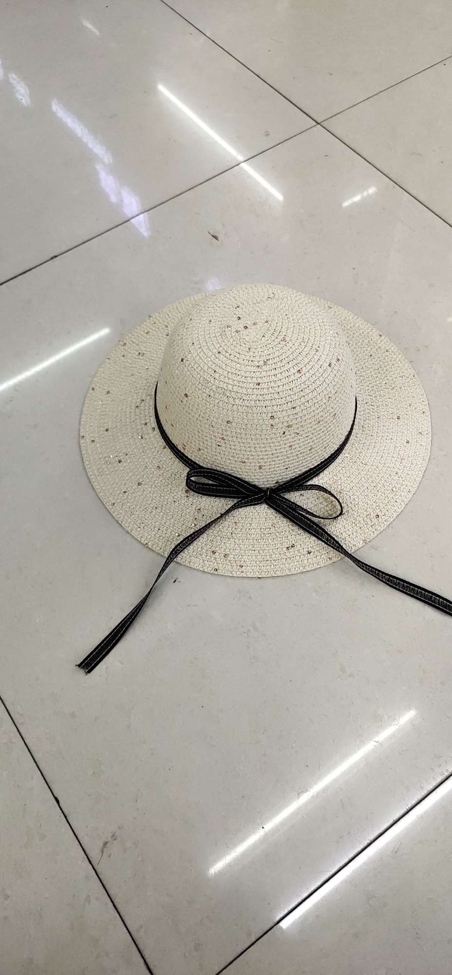 A children's hat with sequined paper braids