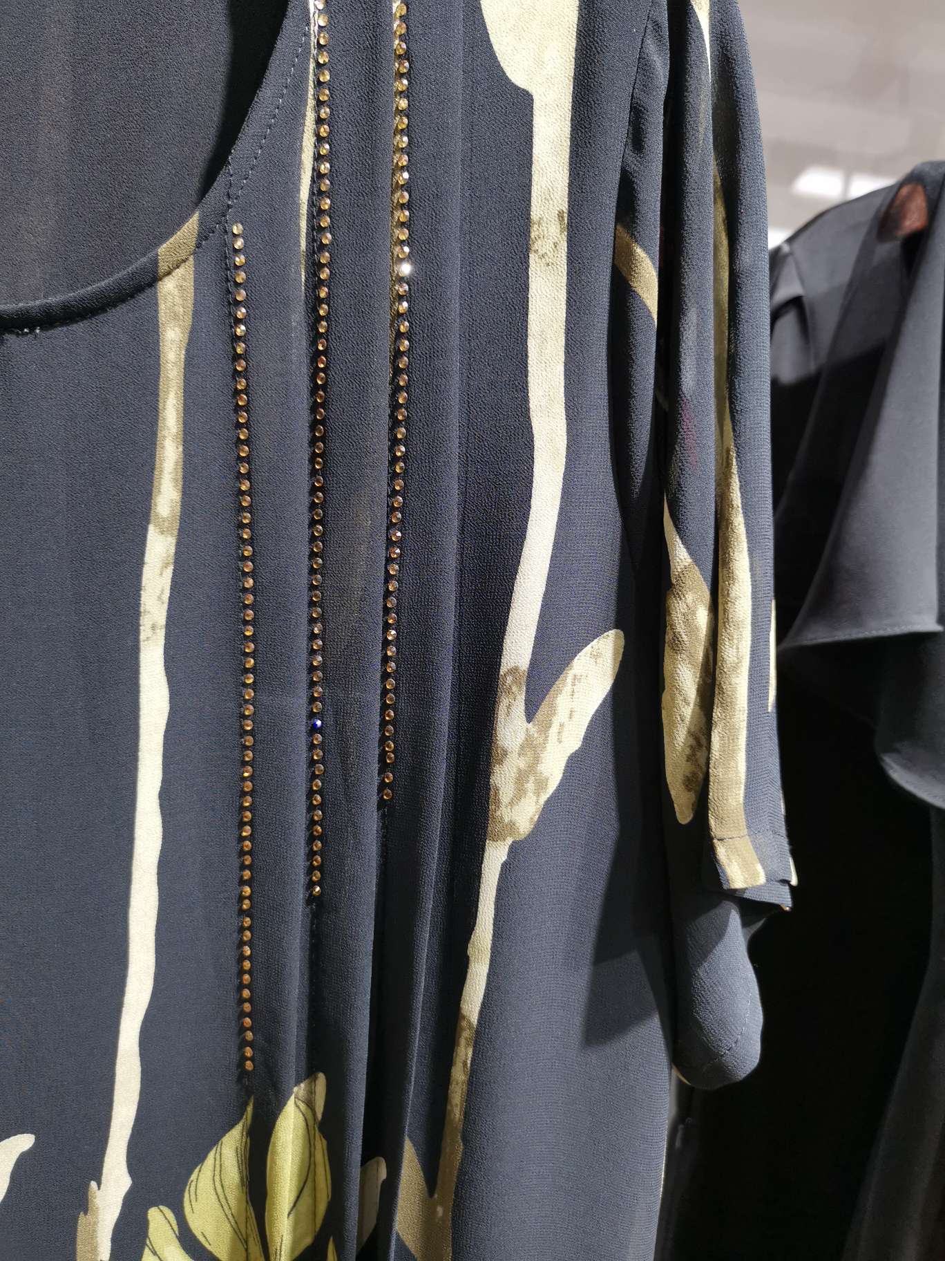 A loose long dress with multiple diamond straps and a large round neck details Picture