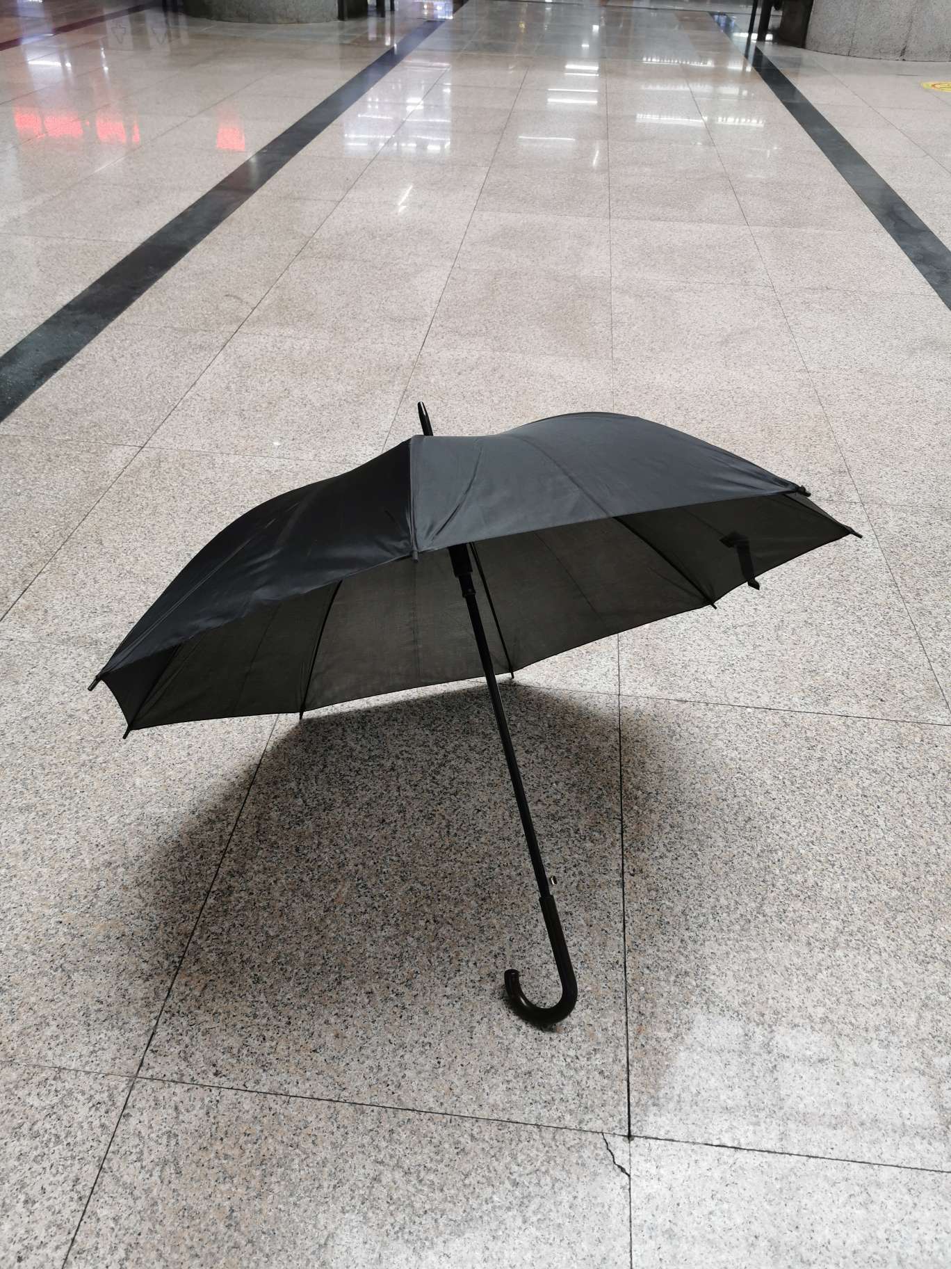 The "Little Black Umbrella" funeral product features a straight, all-black umbrella Specification image