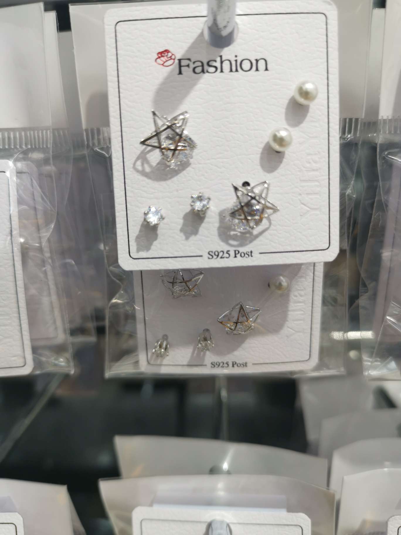 Three pairs of small five-star ear studs