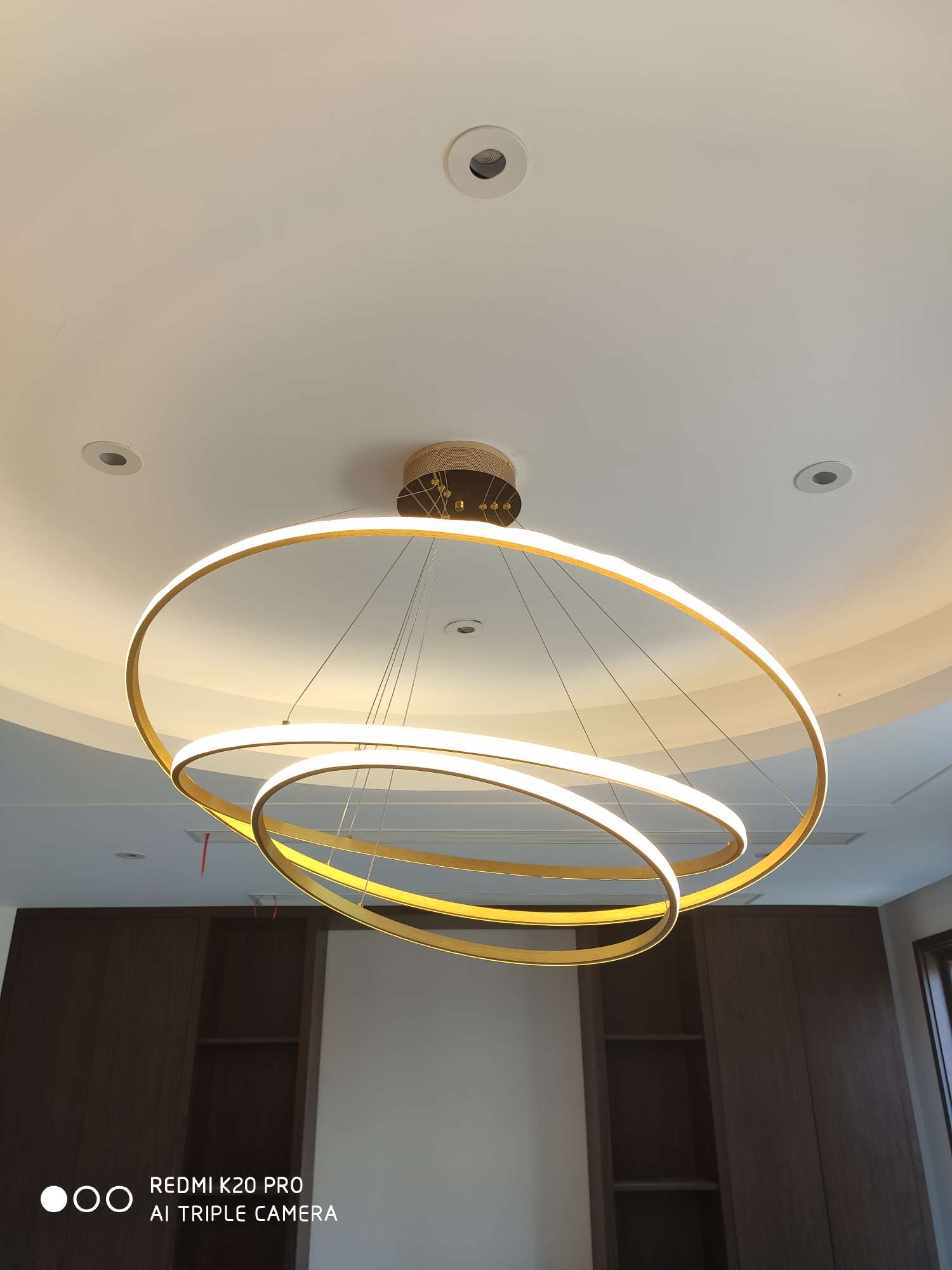 A round chandelier in the living room with a national trend style