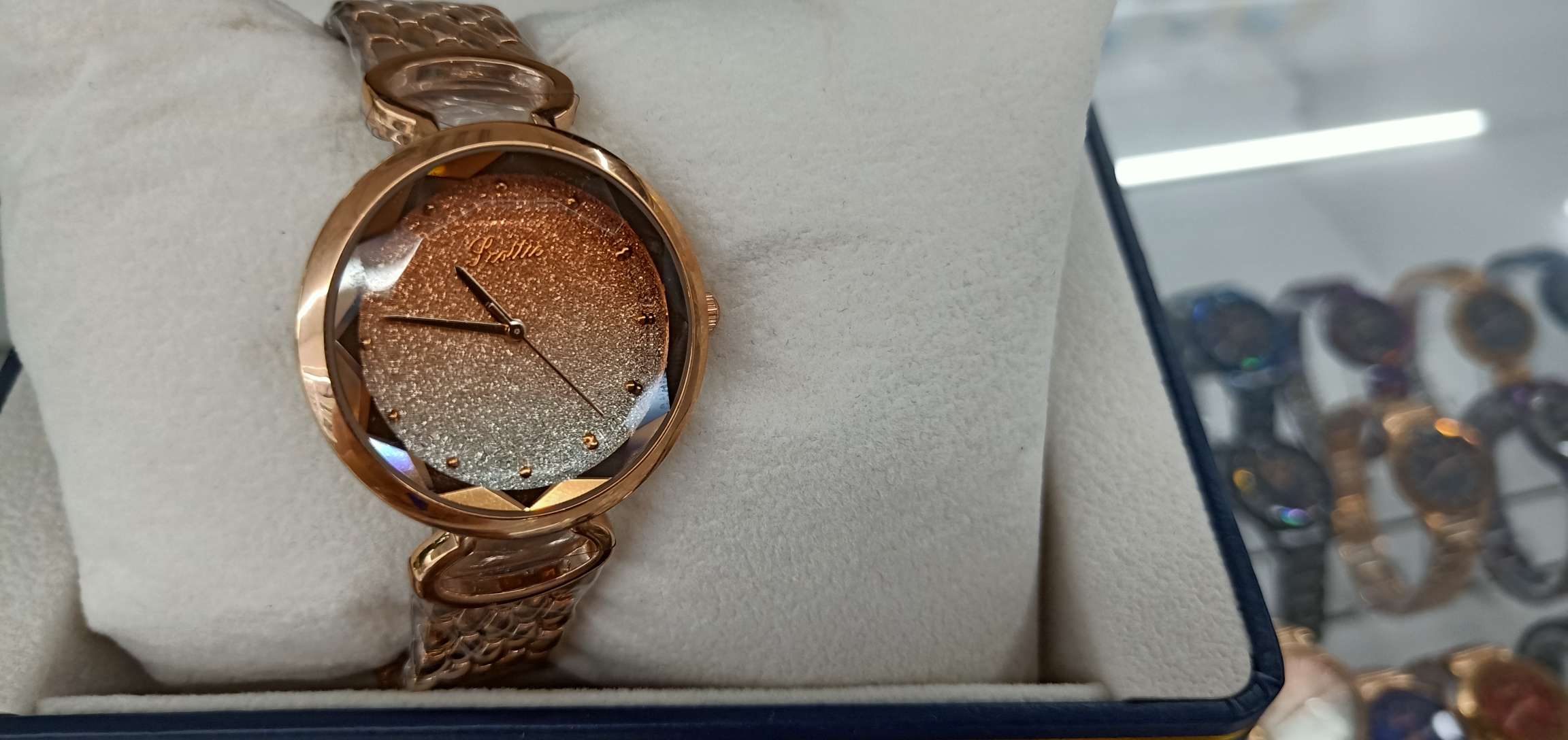 A beautiful ladies' watch with blurred yellow sand patterns and dazzling colors