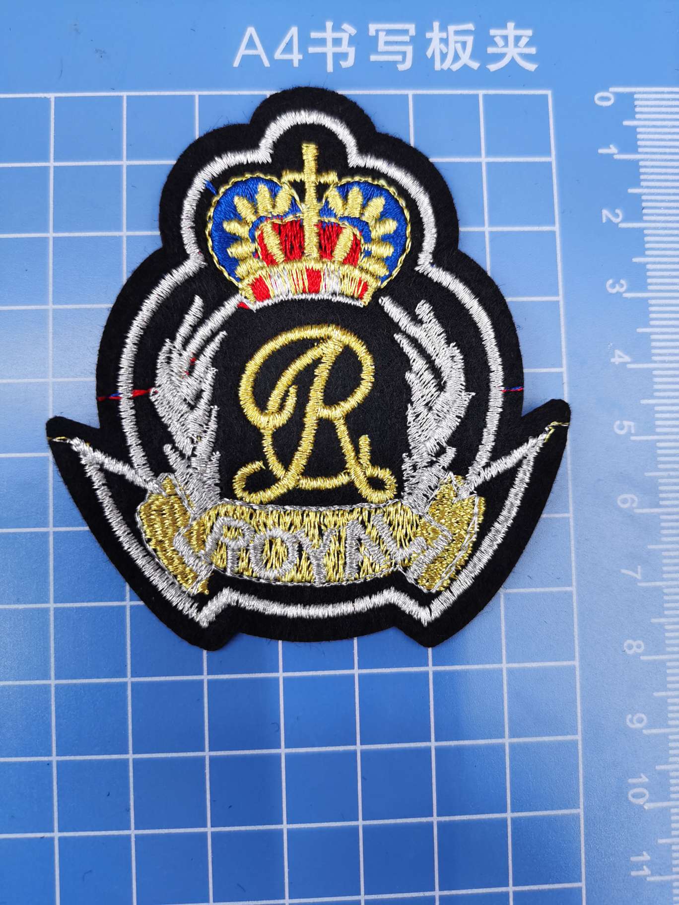 Gold and silver thread crown badge