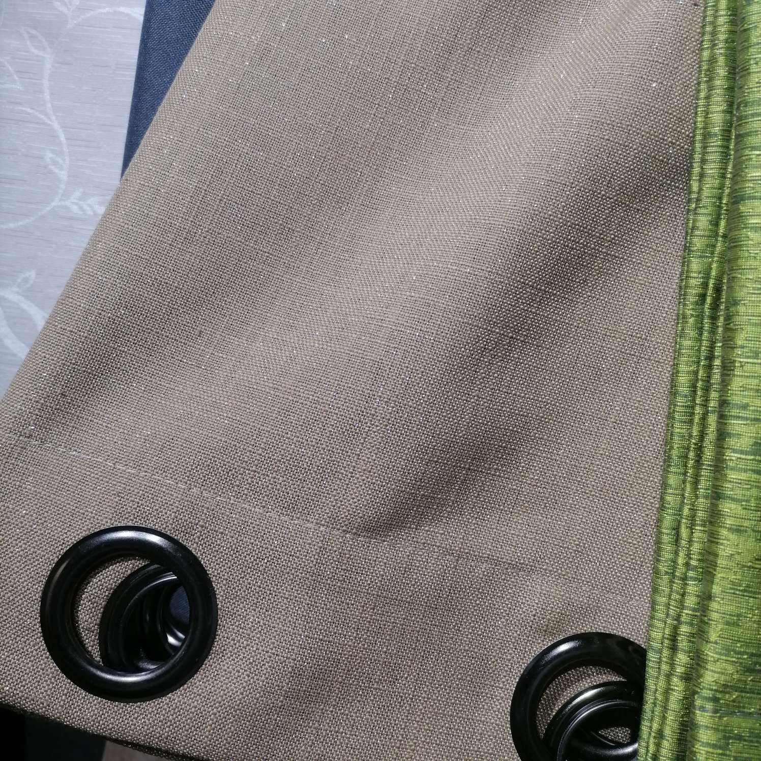 The perforated curtains are yellowish-brown