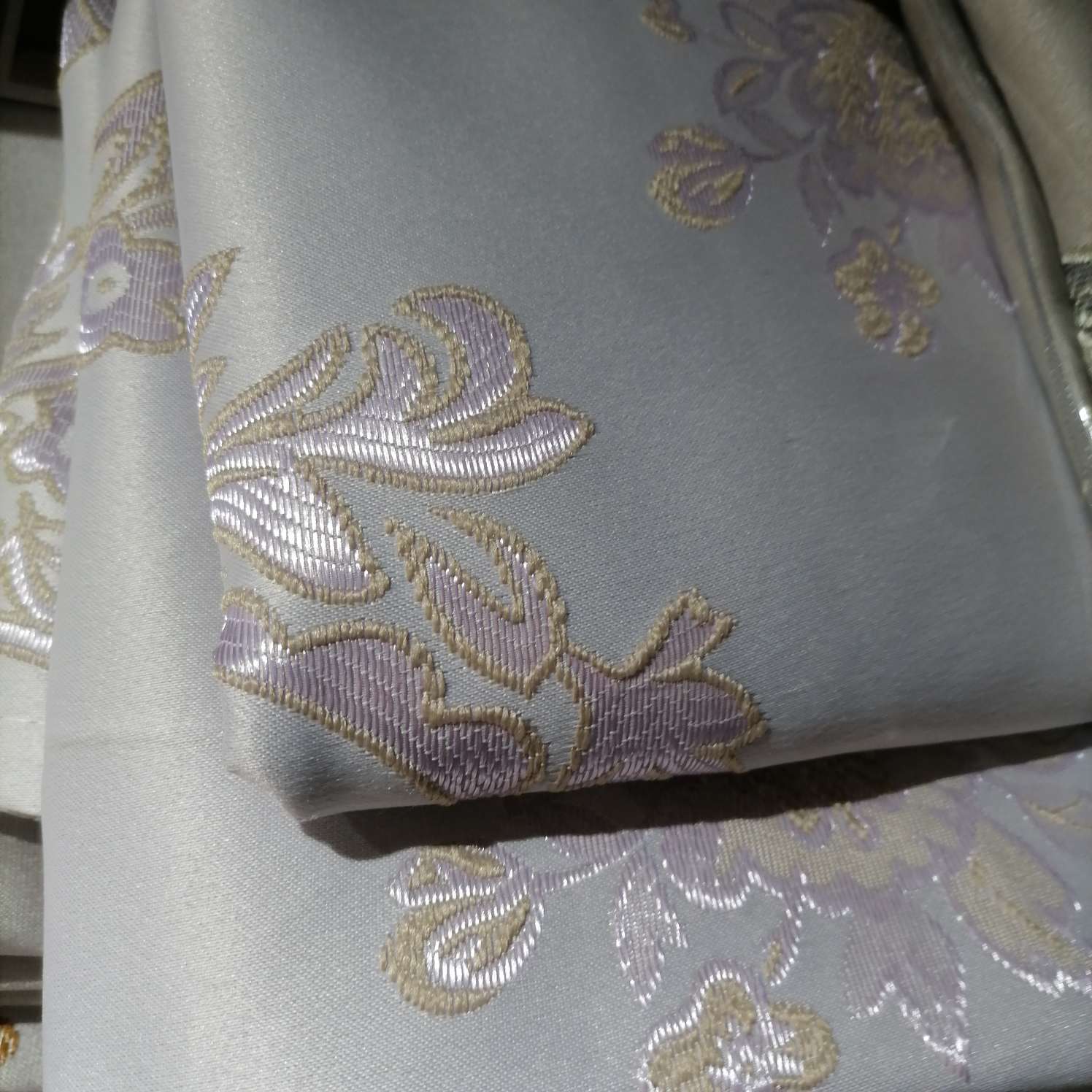Perforated curtains embroidered in purple